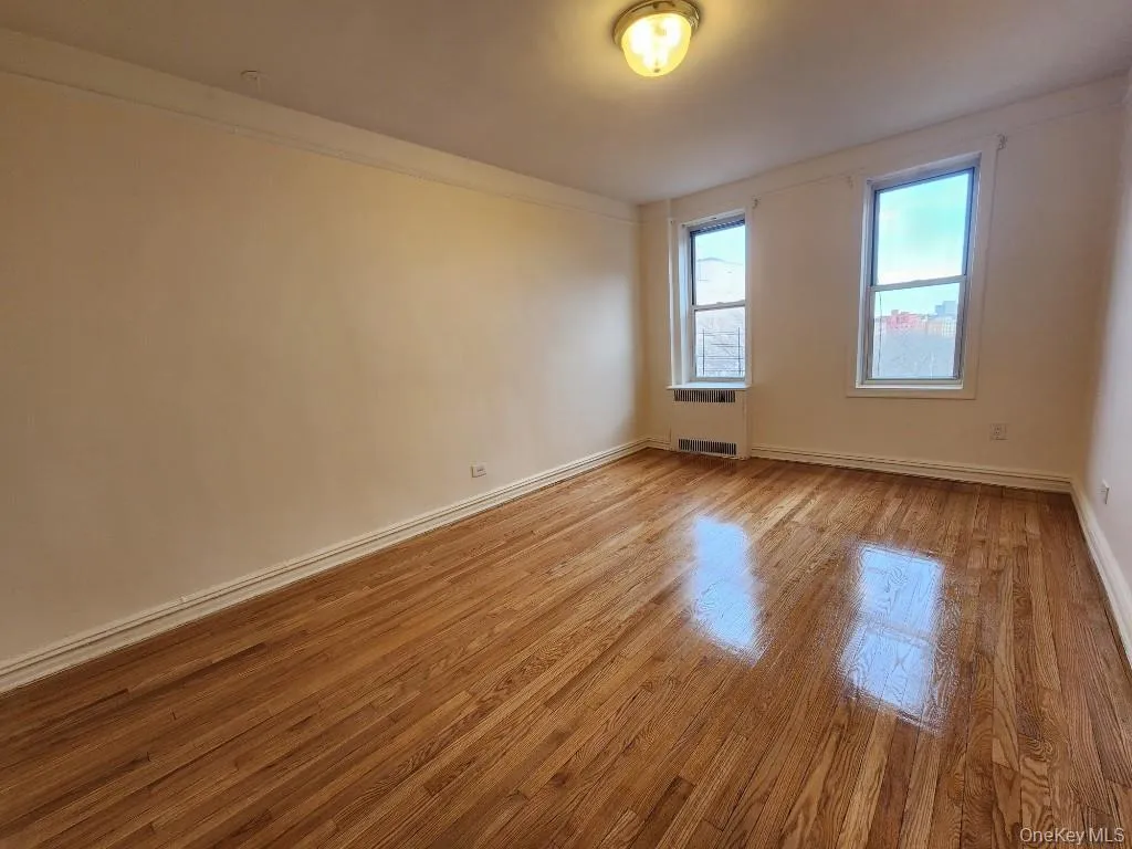 Spare room featuring light wood-style flooring and baseboards Spare room featuring light wood-style flooring and baseboards
