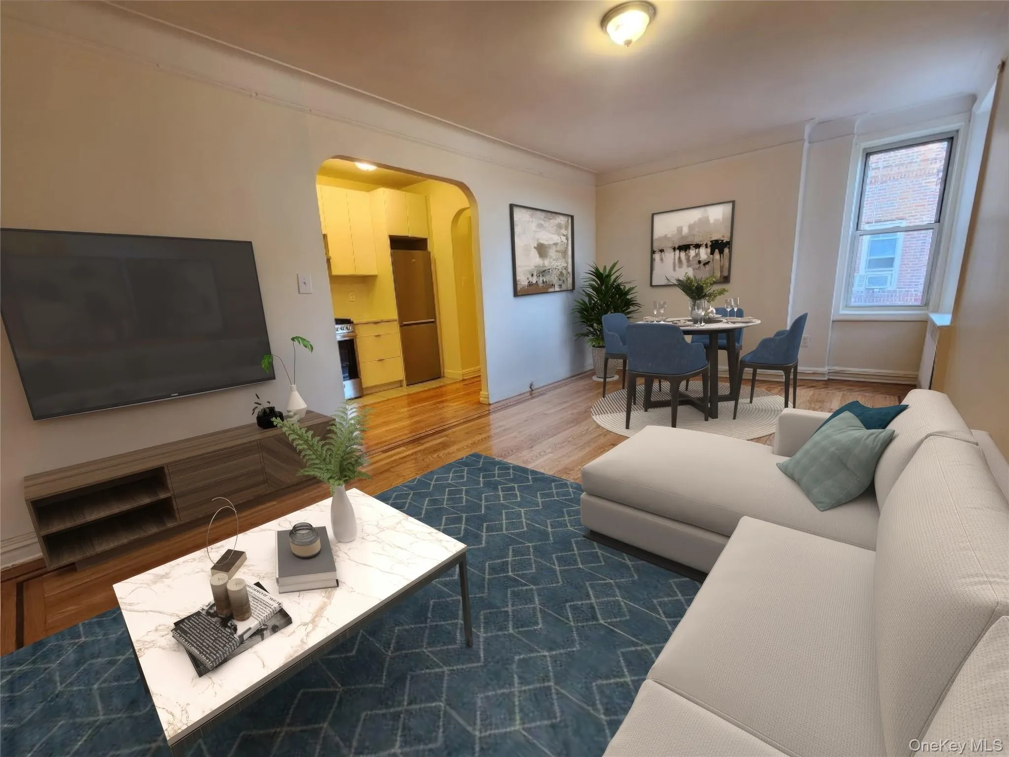 Living area featuring arched walkways, wood finished floors, and ornamental molding Living area featuring arched walkways, wood finished floors, and ornamental molding