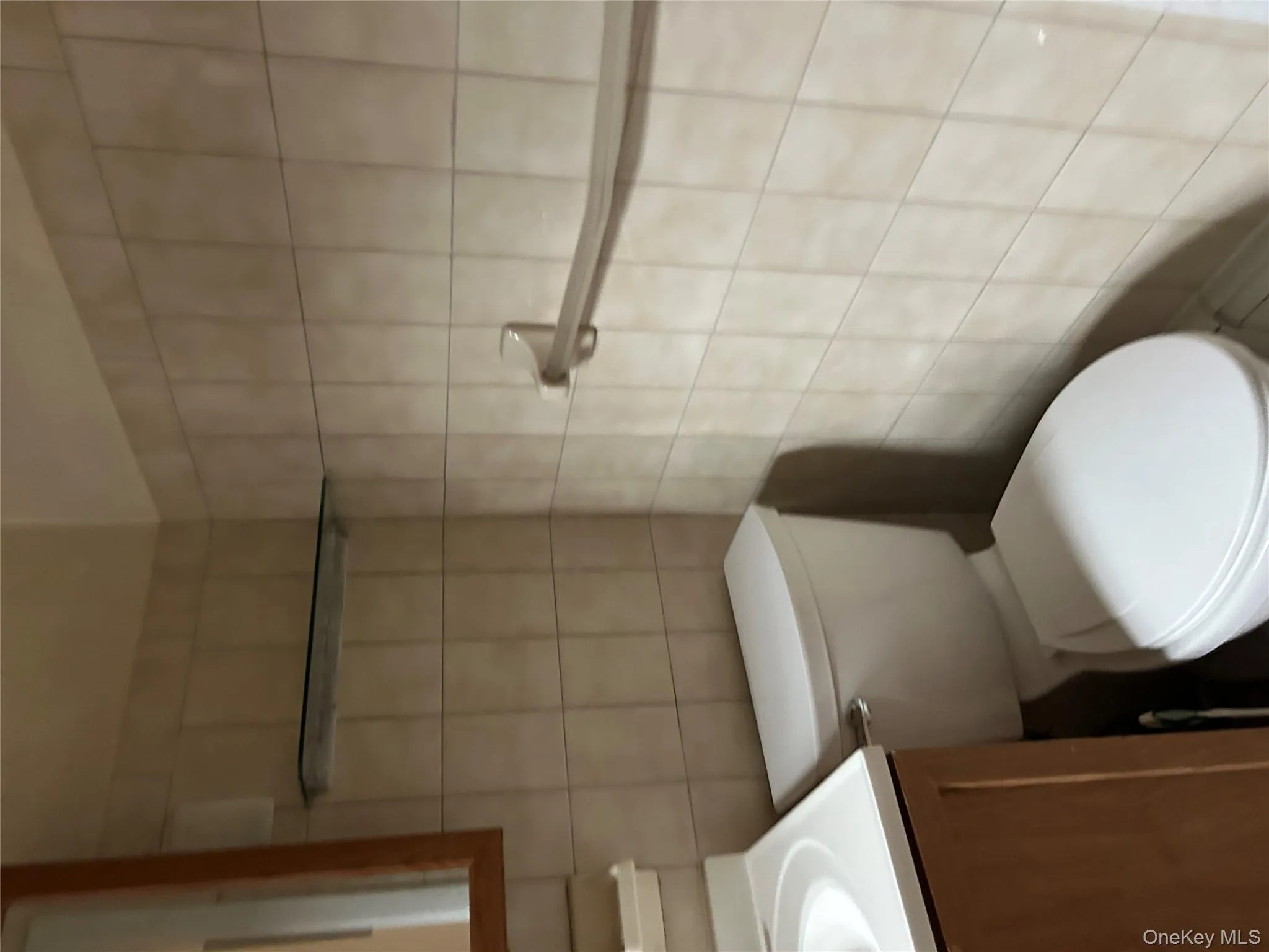 Half bathroom with tile walls and vanity Half bathroom with tile walls and vanity