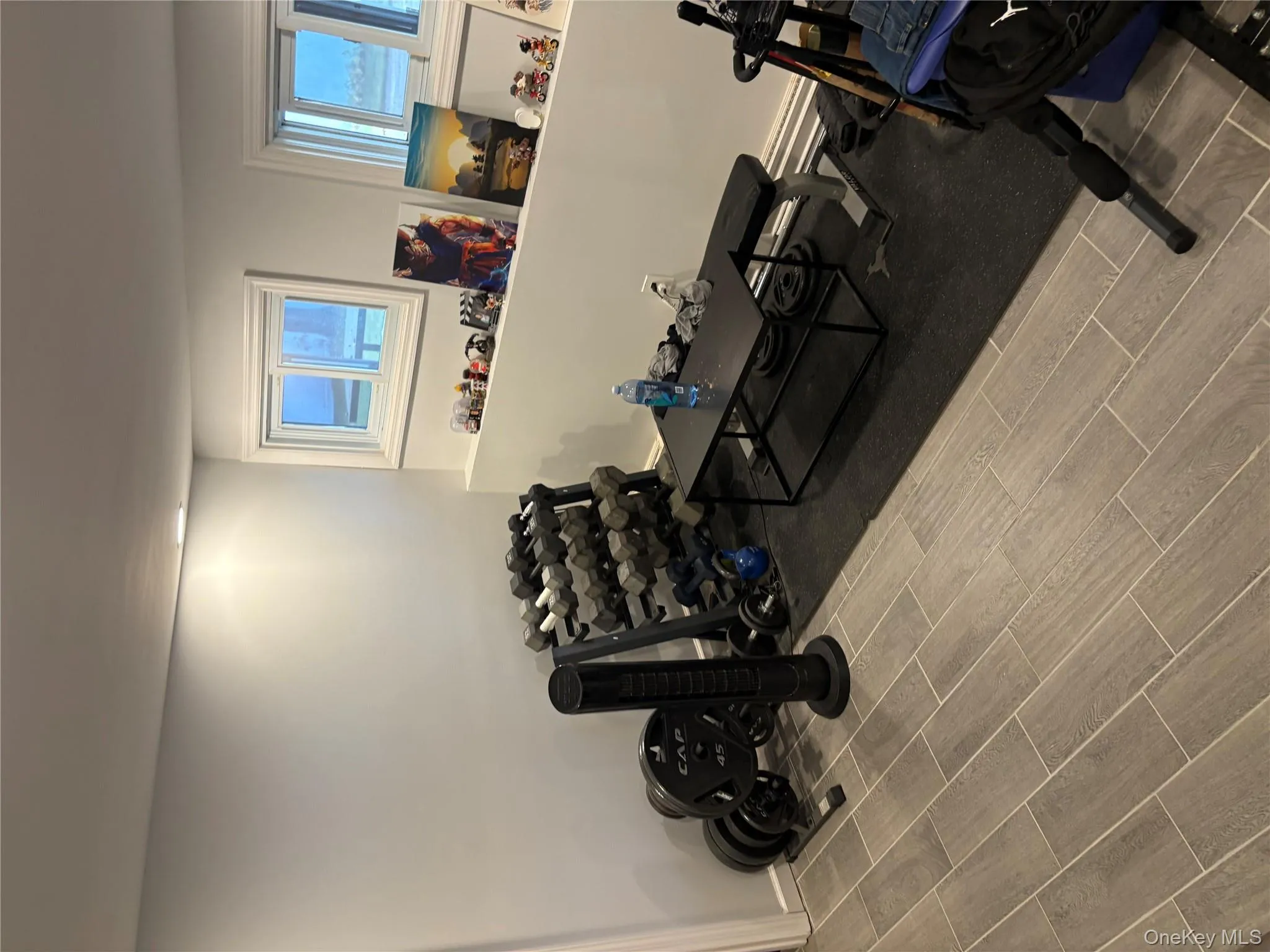 Exercise area featuring wood tiled floors and healthy amount of natural light Exercise area featuring wood tiled floors and healthy amount of natural light