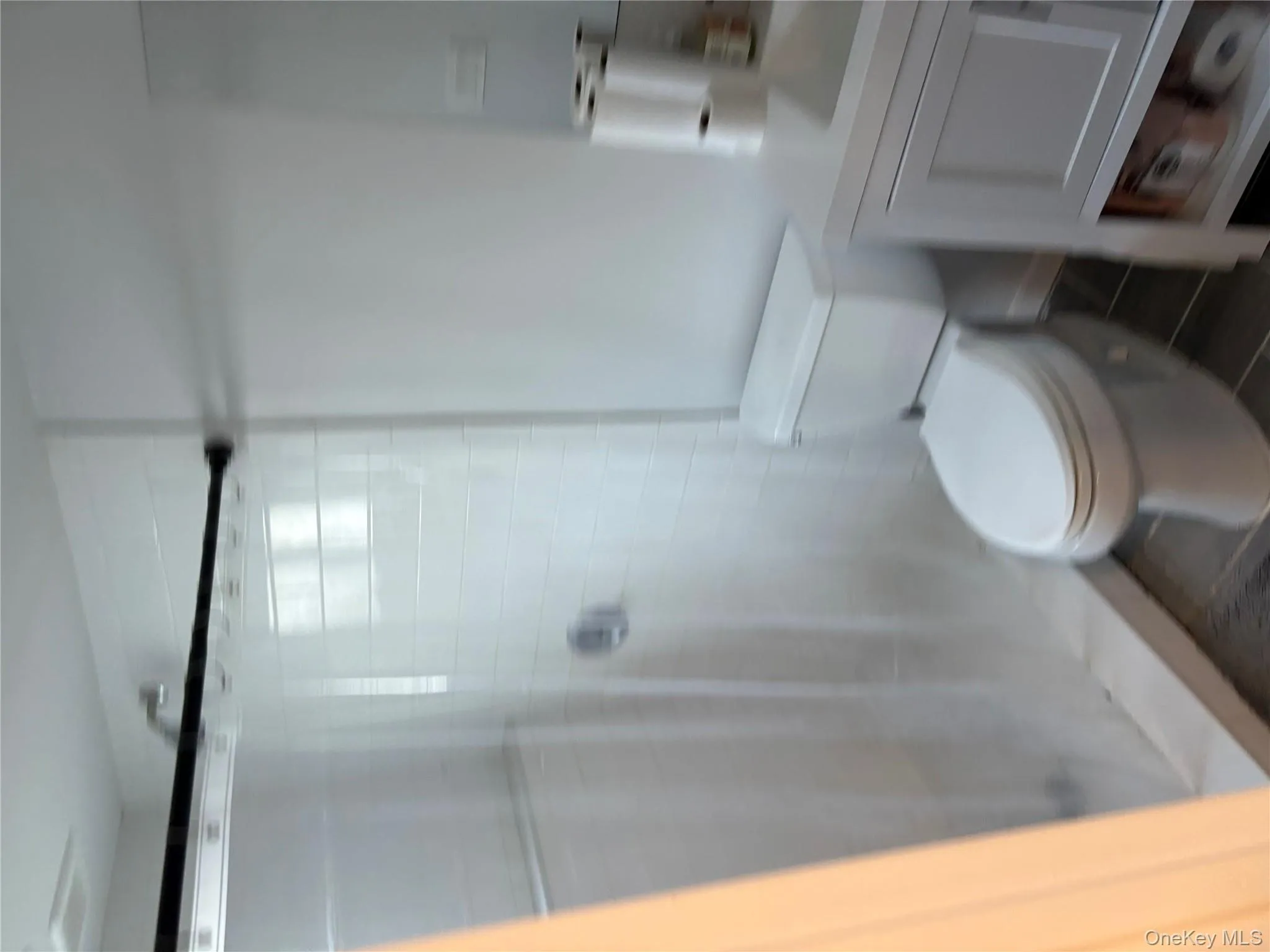 Bathroom with vanity and a shower stall Bathroom with vanity and a shower stall