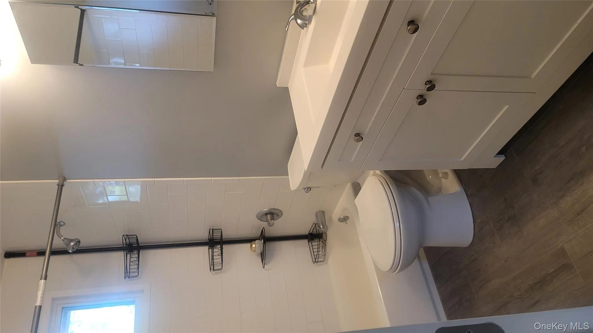 Full bath with dark wood-type flooring, vanity, and shower / tub combination Full bath with dark wood-type flooring, vanity, and shower / tub combination