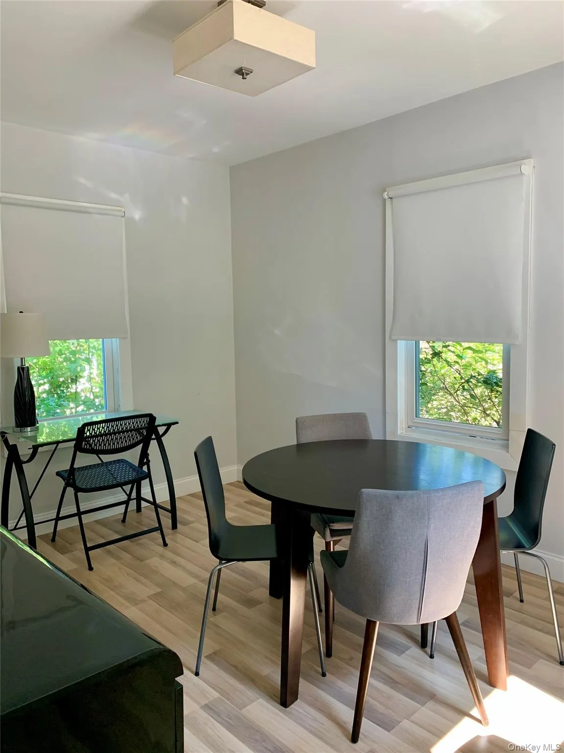 Dining space with light wood-style flooring and baseboards Dining space with light wood-style flooring and baseboards