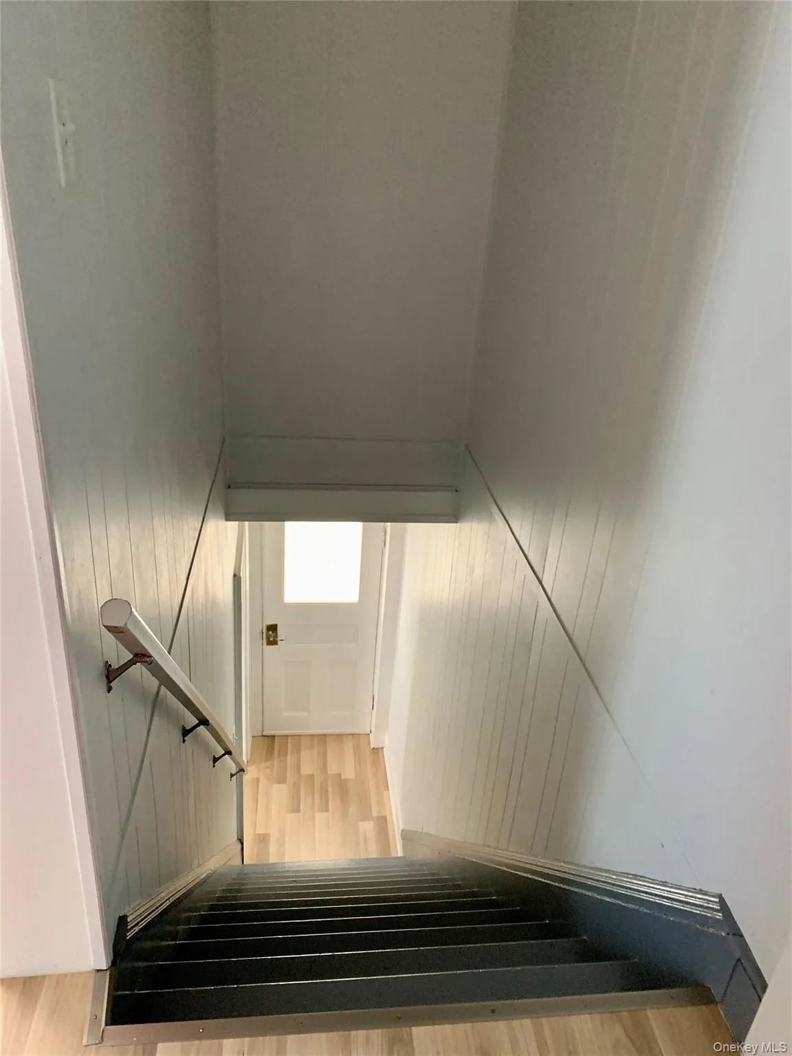 Staircase featuring wood finished floors Staircase featuring wood finished floors