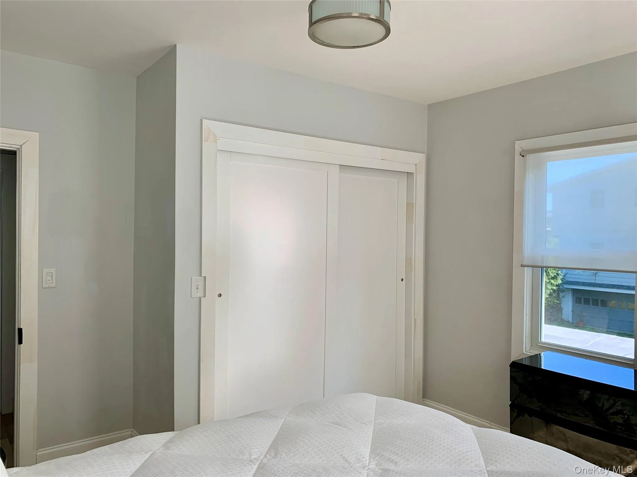 Bedroom with a closet and baseboards Bedroom with a closet and baseboards