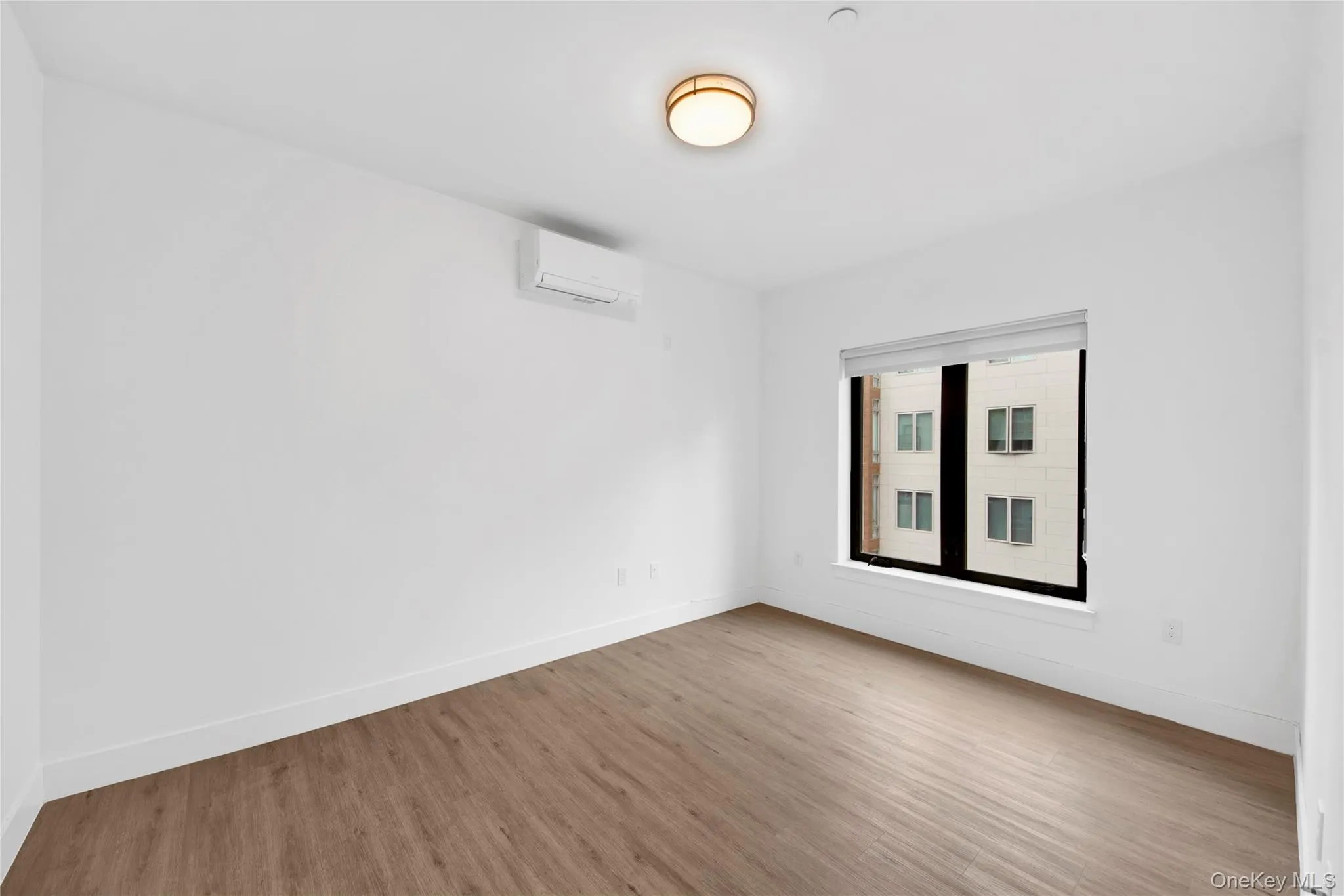 Unfurnished room with wood finished floors and baseboards Unfurnished room with wood finished floors and baseboards
