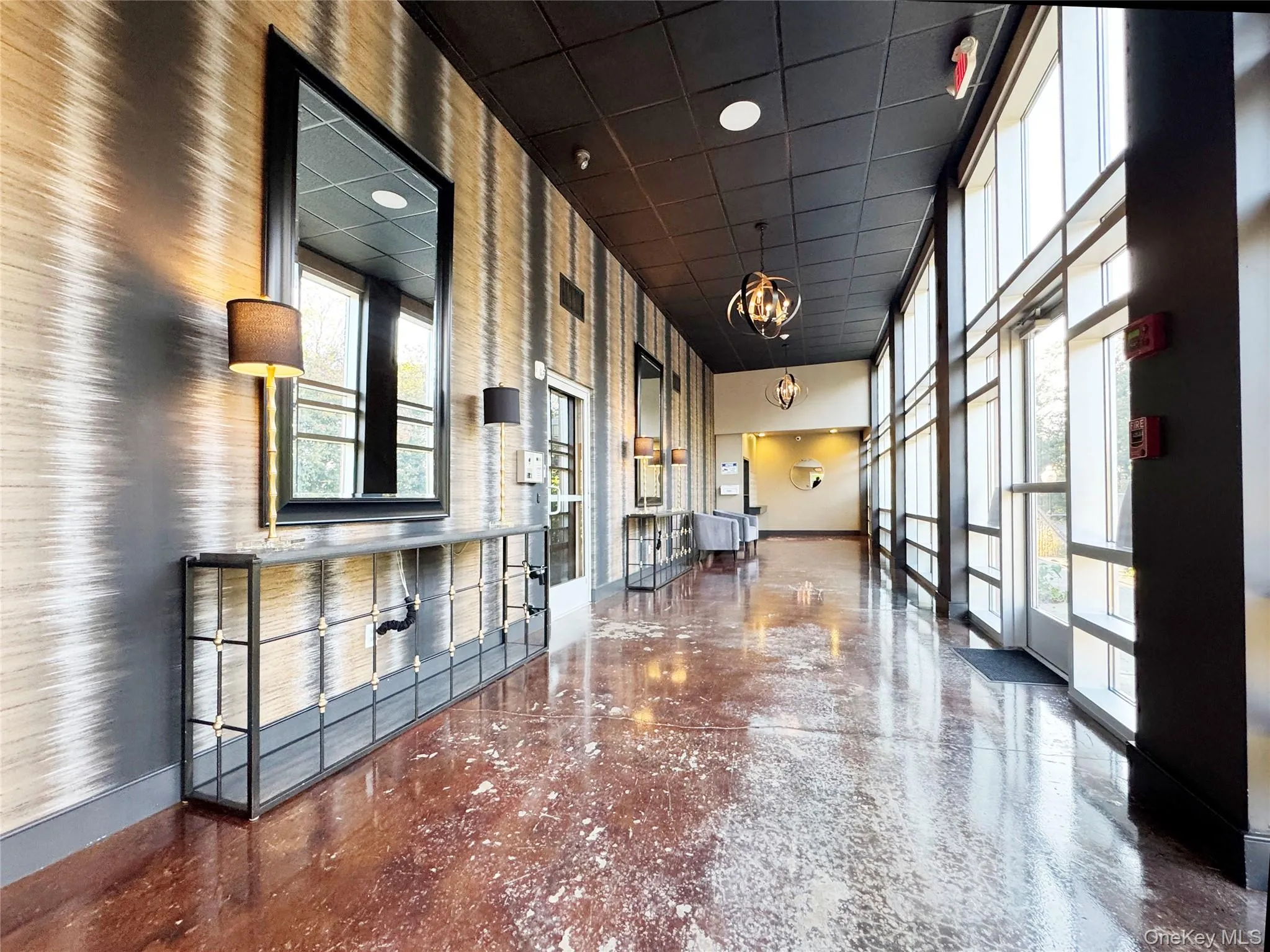 Common area featuring a towering ceiling, a drop ceiling, and recessed lighting Common area featuring a towering ceiling, a drop ceiling, and recessed lighting