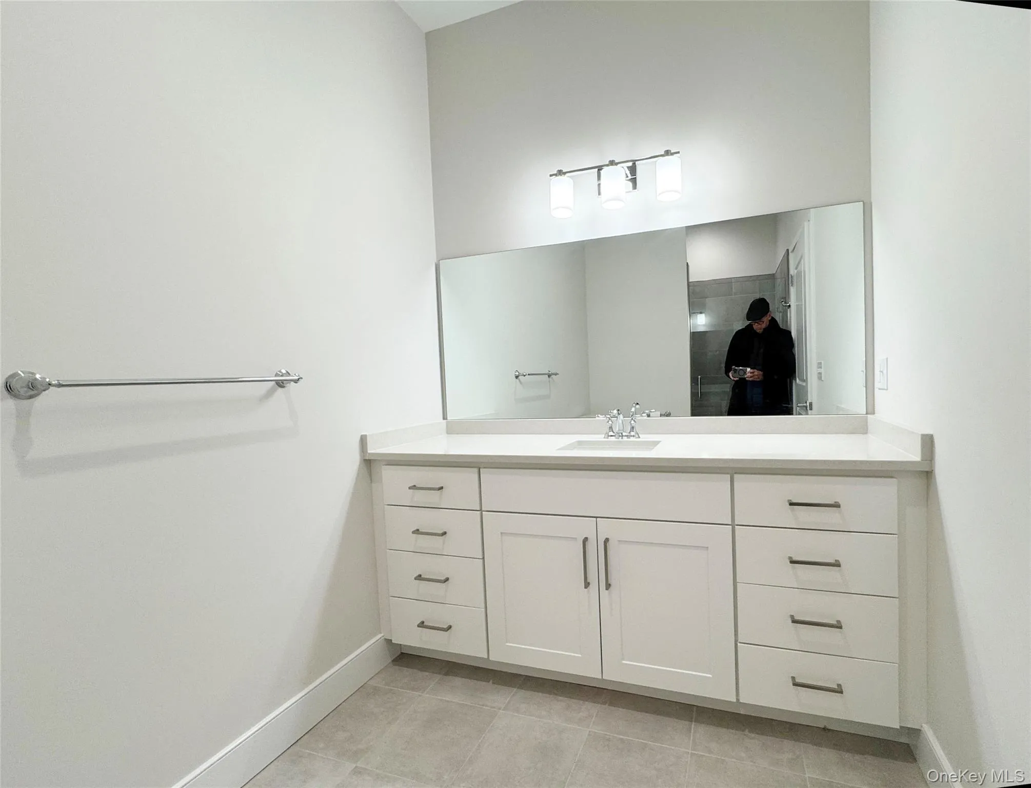 Bathroom with vanity and light tile patterned floors Bathroom with vanity and light tile patterned floors