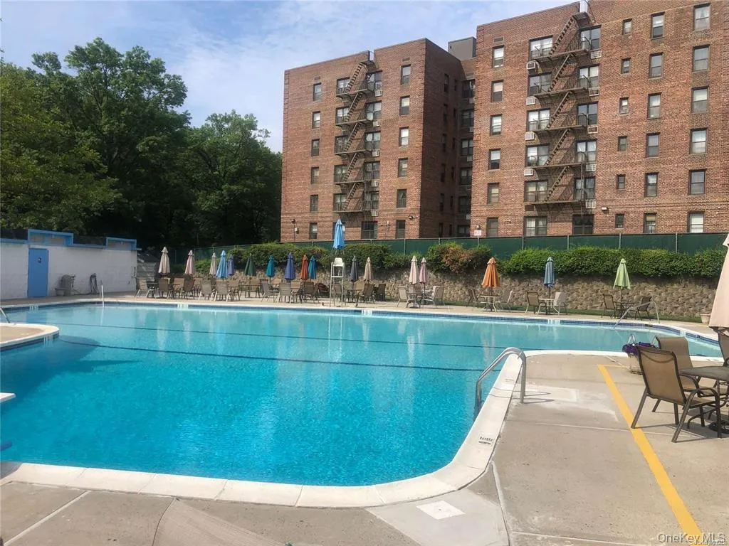 Community pool with a patio area Community pool with a patio area