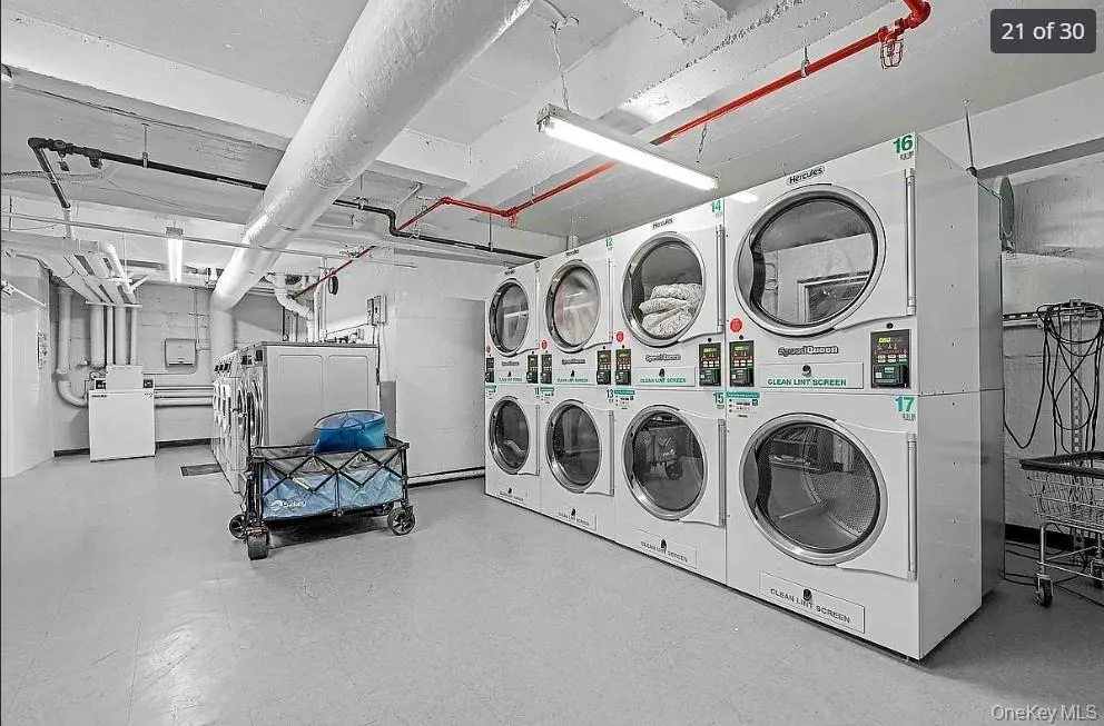Community laundry room with washer and dryer and stacked washer / drying machine Community laundry room with washer and dryer and stacked washer / drying machine