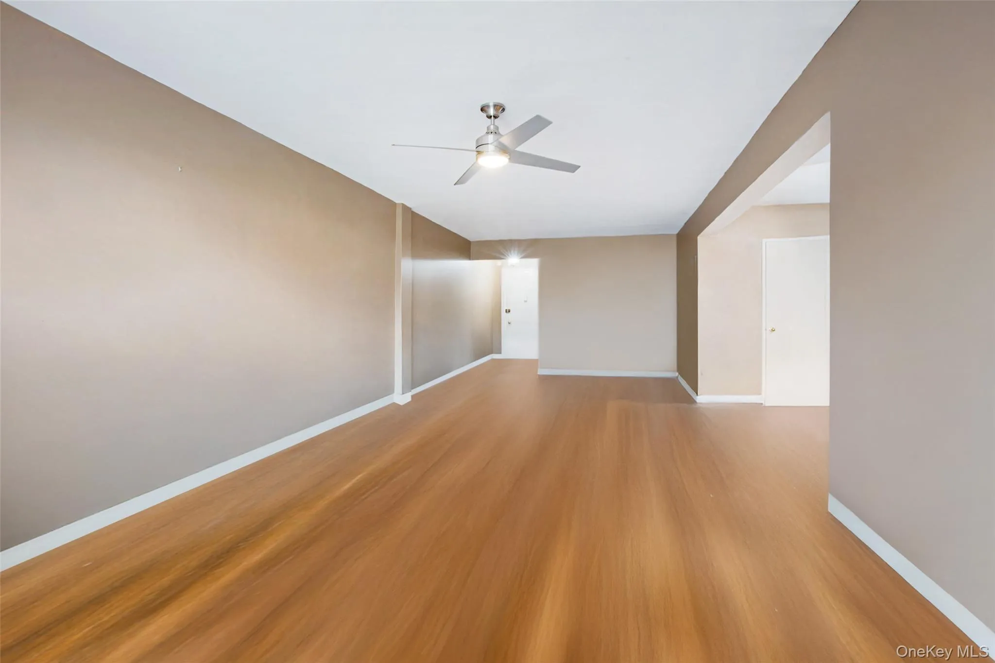 Unfurnished room with light wood finished floors and ceiling fan Unfurnished room with light wood finished floors and ceiling fan