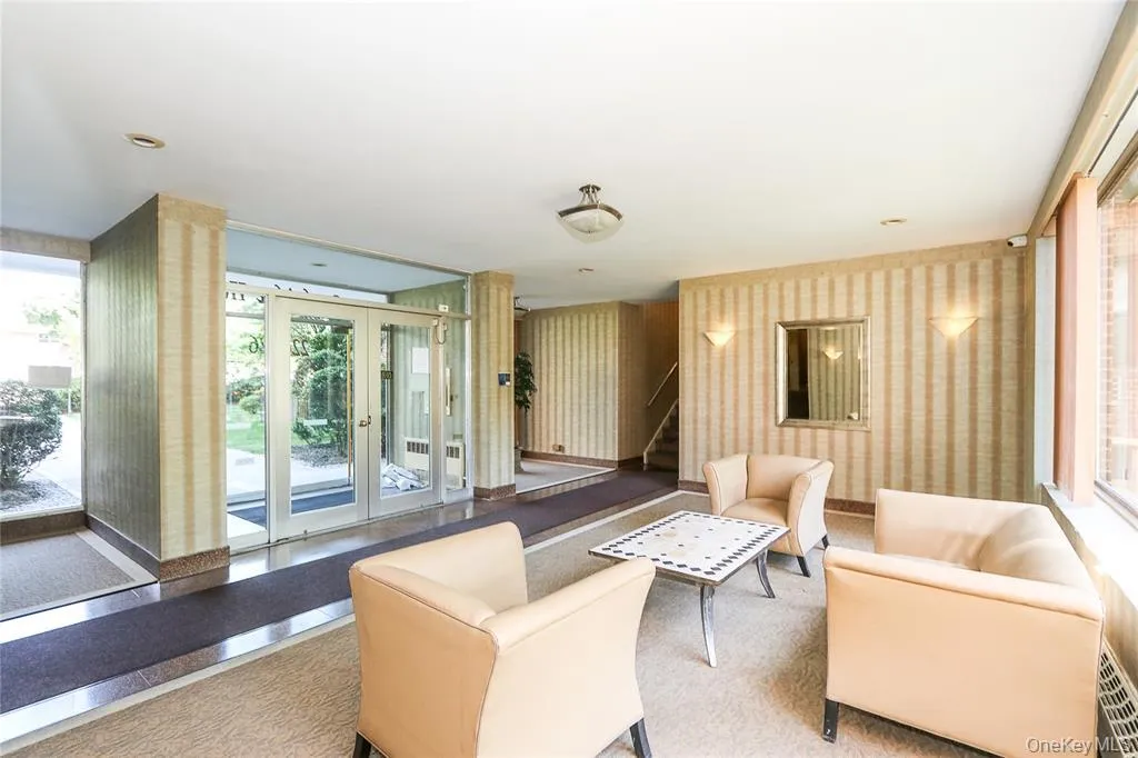 Common area featuring wallpapered walls and stairs Common area featuring wallpapered walls and stairs
