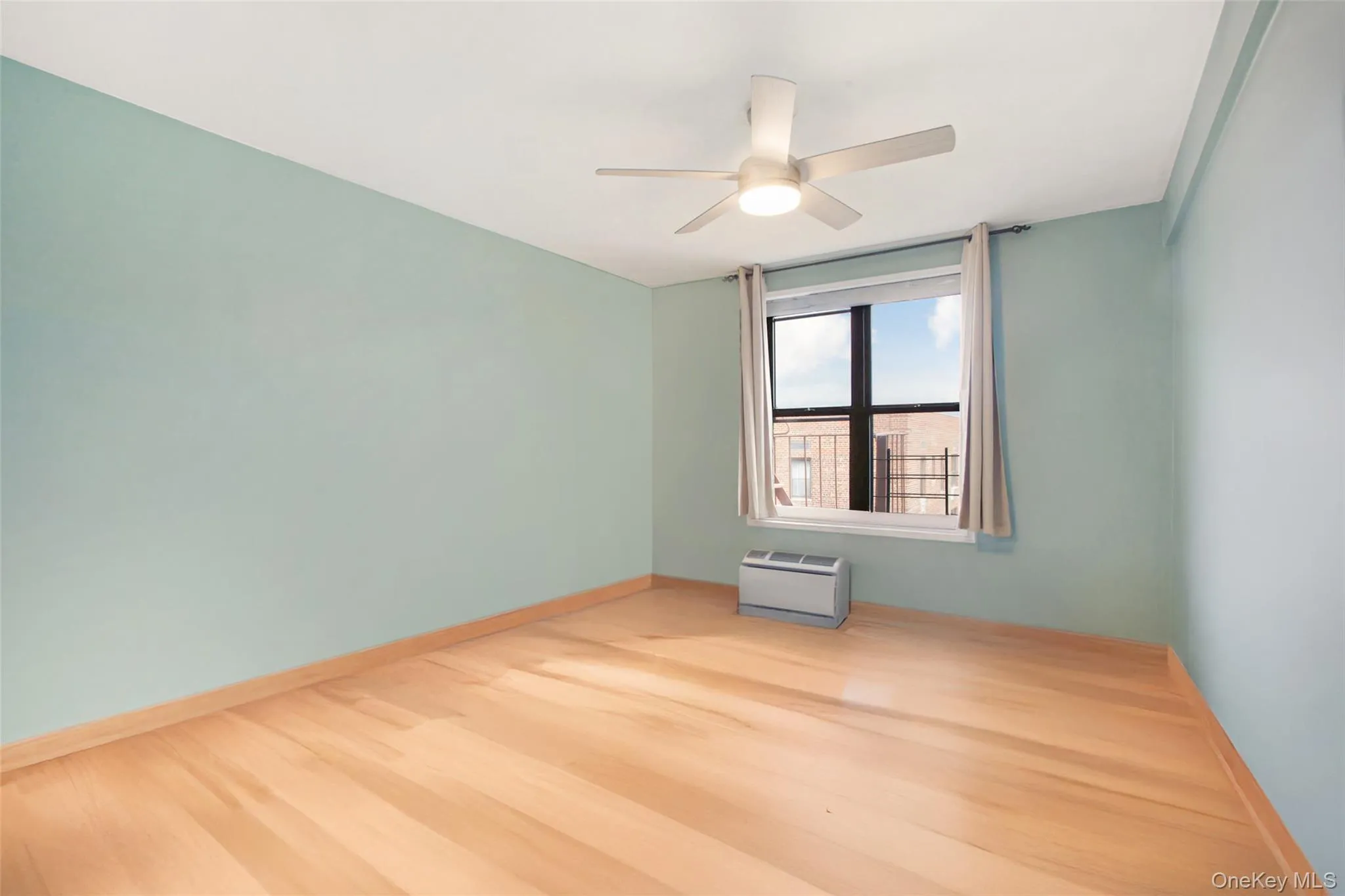 Spare room featuring wood finished floors and ceiling fan Spare room featuring wood finished floors and ceiling fan