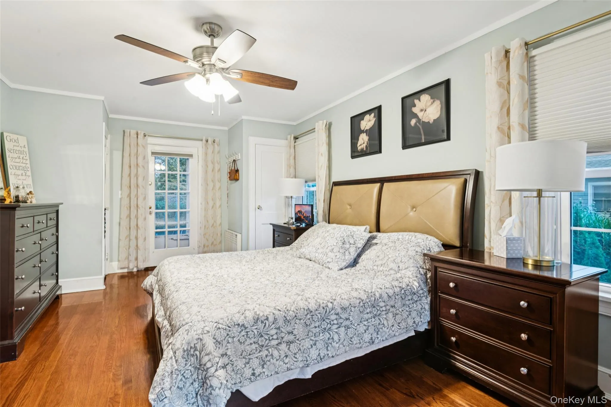 Bedroom with ornamental molding, dark wood-style floors, and ceiling fan Bedroom with ornamental molding, dark wood-style floors, and ceiling fan