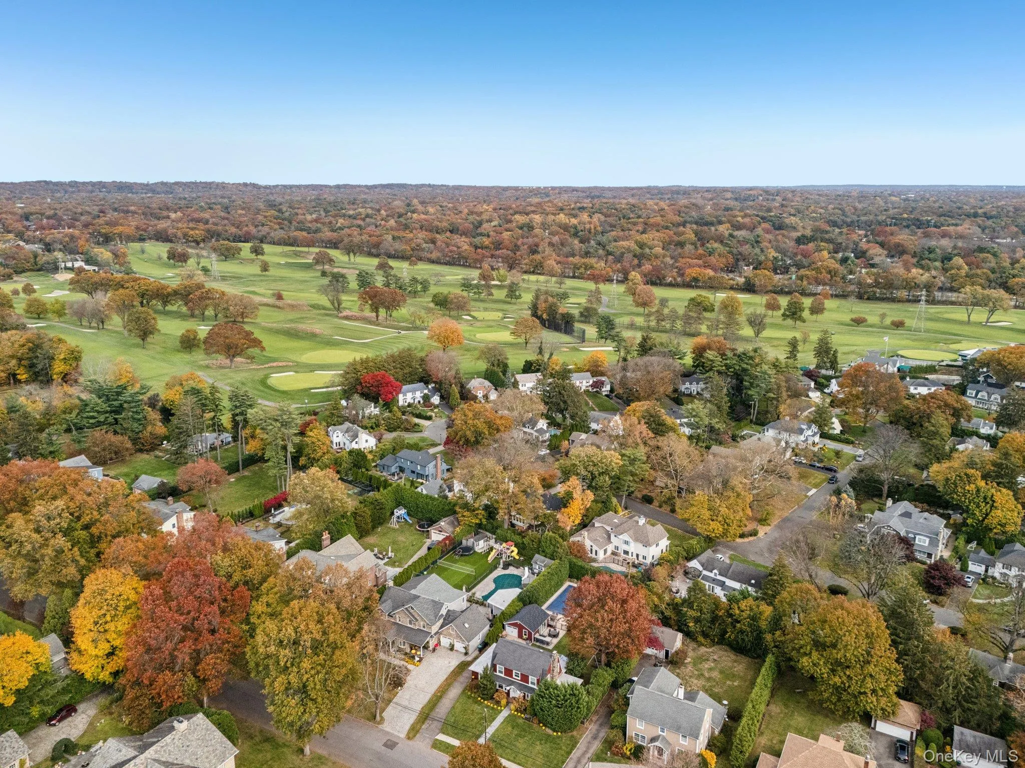View of property location with a golf course and nearby suburban area View of property location with a golf course and nearby suburban area