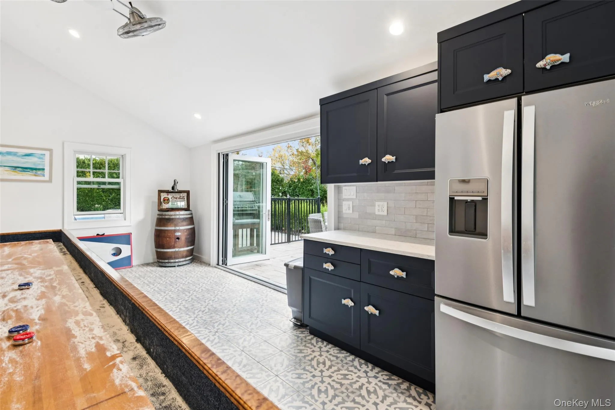 Kitchen featuring stainless steel refrigerator with ice dispenser, lofted ceiling, healthy amount of natural light, backsplash, and recessed lighting Kitchen featuring stainless steel refrigerator with ice dispenser, lofted ceiling, healthy amount of natural light, backsplash, and recessed lighting