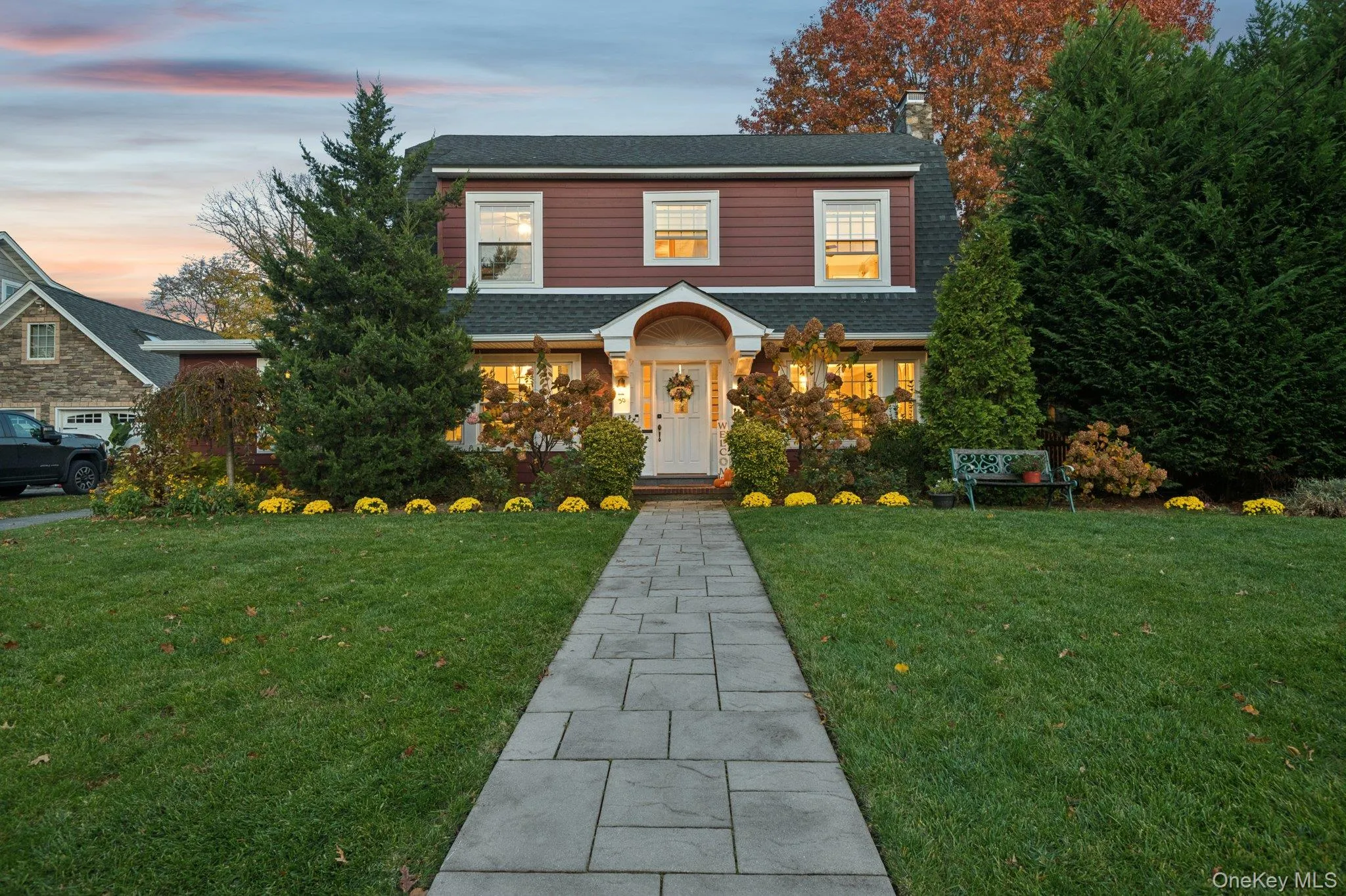 View of front of house with a yard, roof with shingles, and a chimney View of front of house with a yard, roof with shingles, and a chimney