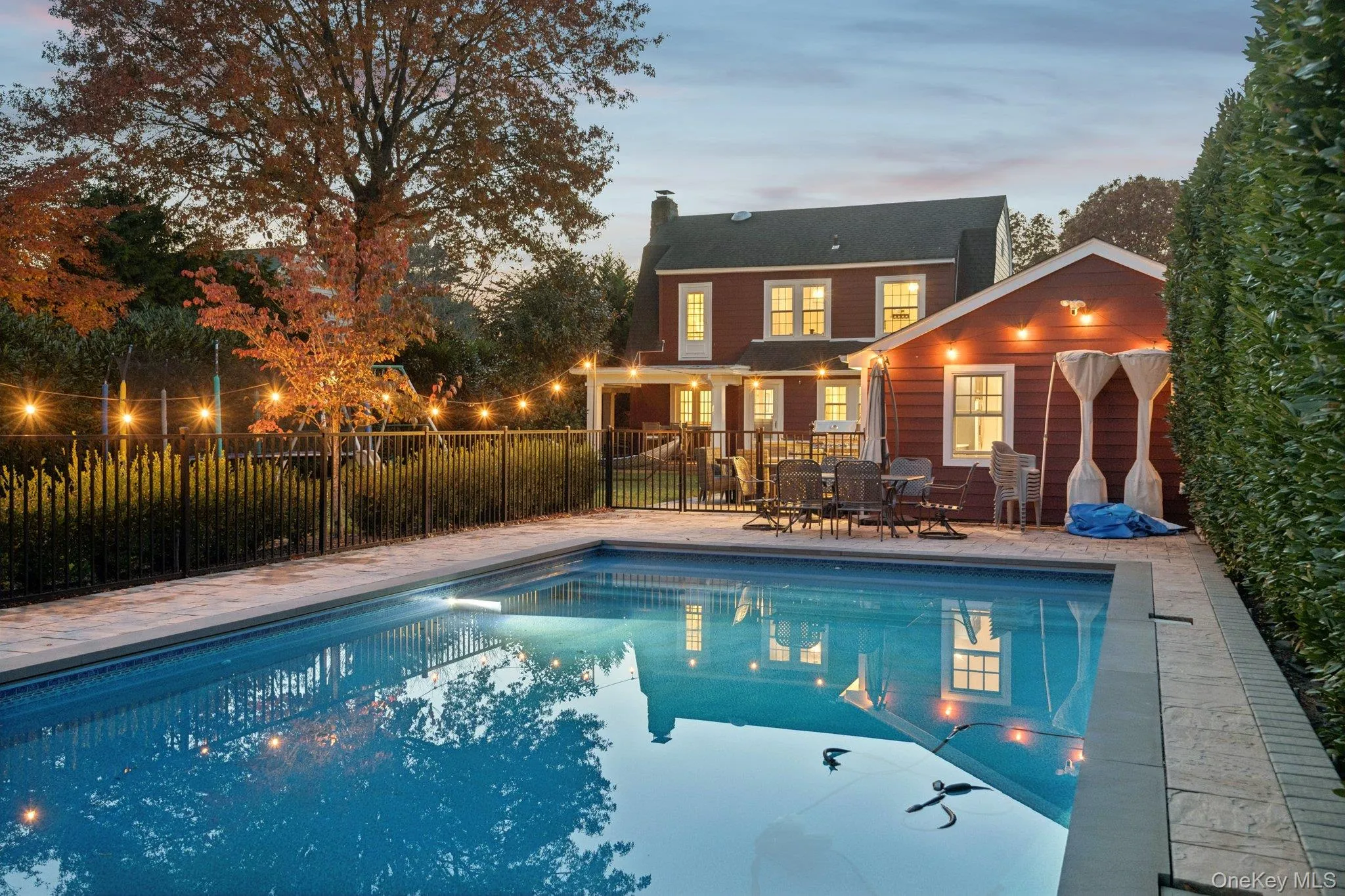 View of swimming pool featuring a patio and outdoor dining area View of swimming pool featuring a patio and outdoor dining area