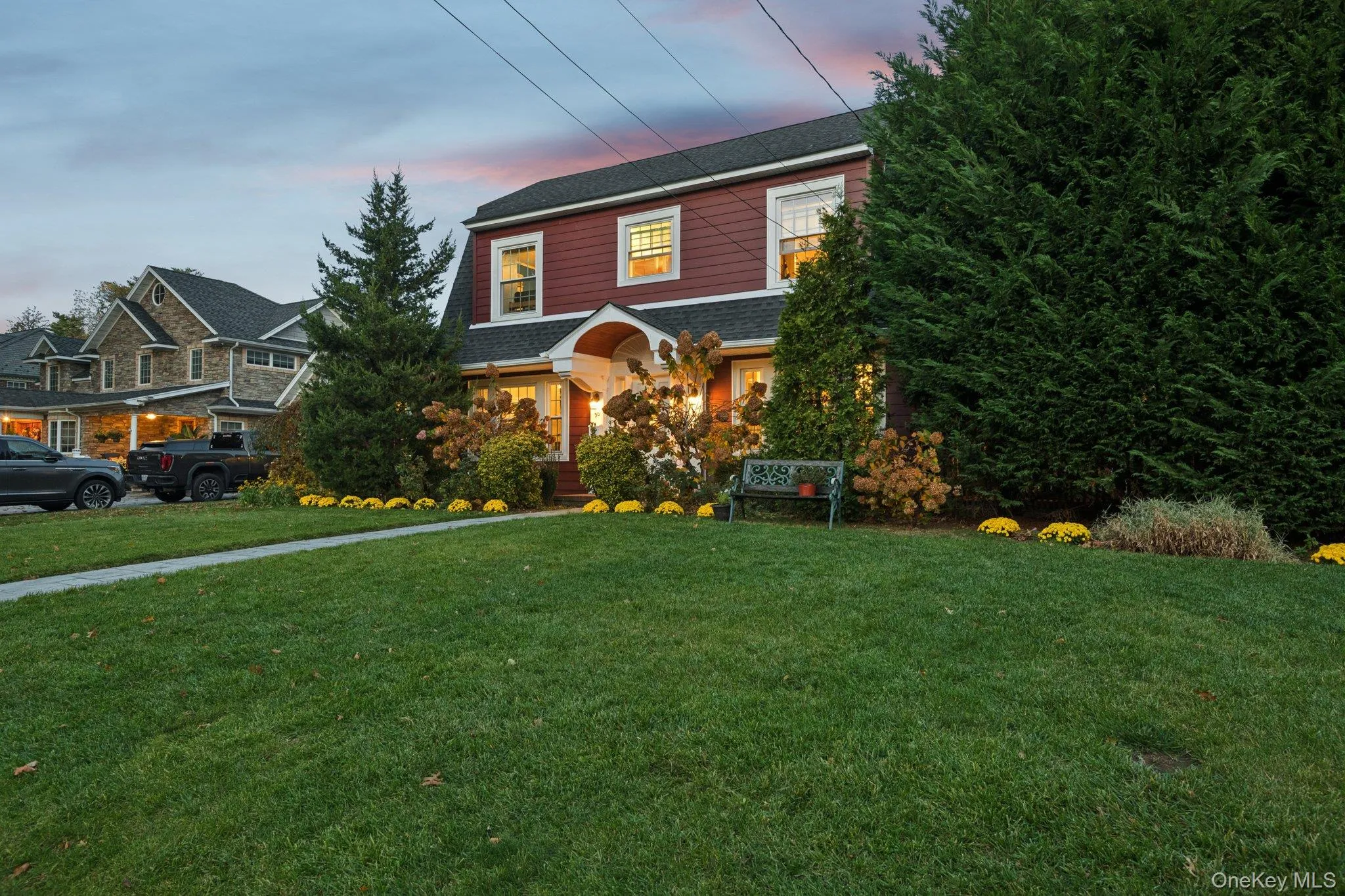 View of front of home with a front yard and roof with shingles View of front of home with a front yard and roof with shingles