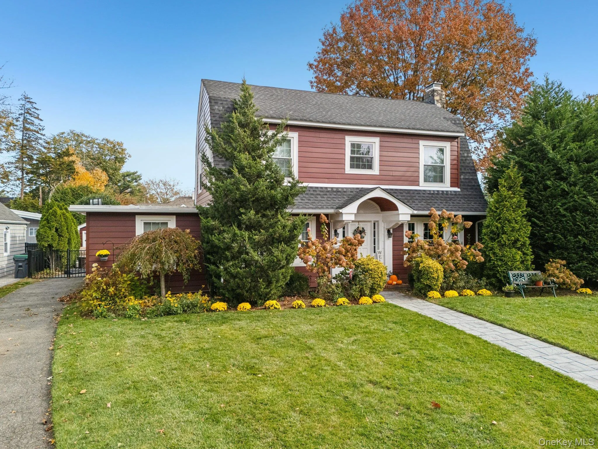 View of front of property featuring a chimney and a shingled roof View of front of property featuring a chimney and a shingled roof