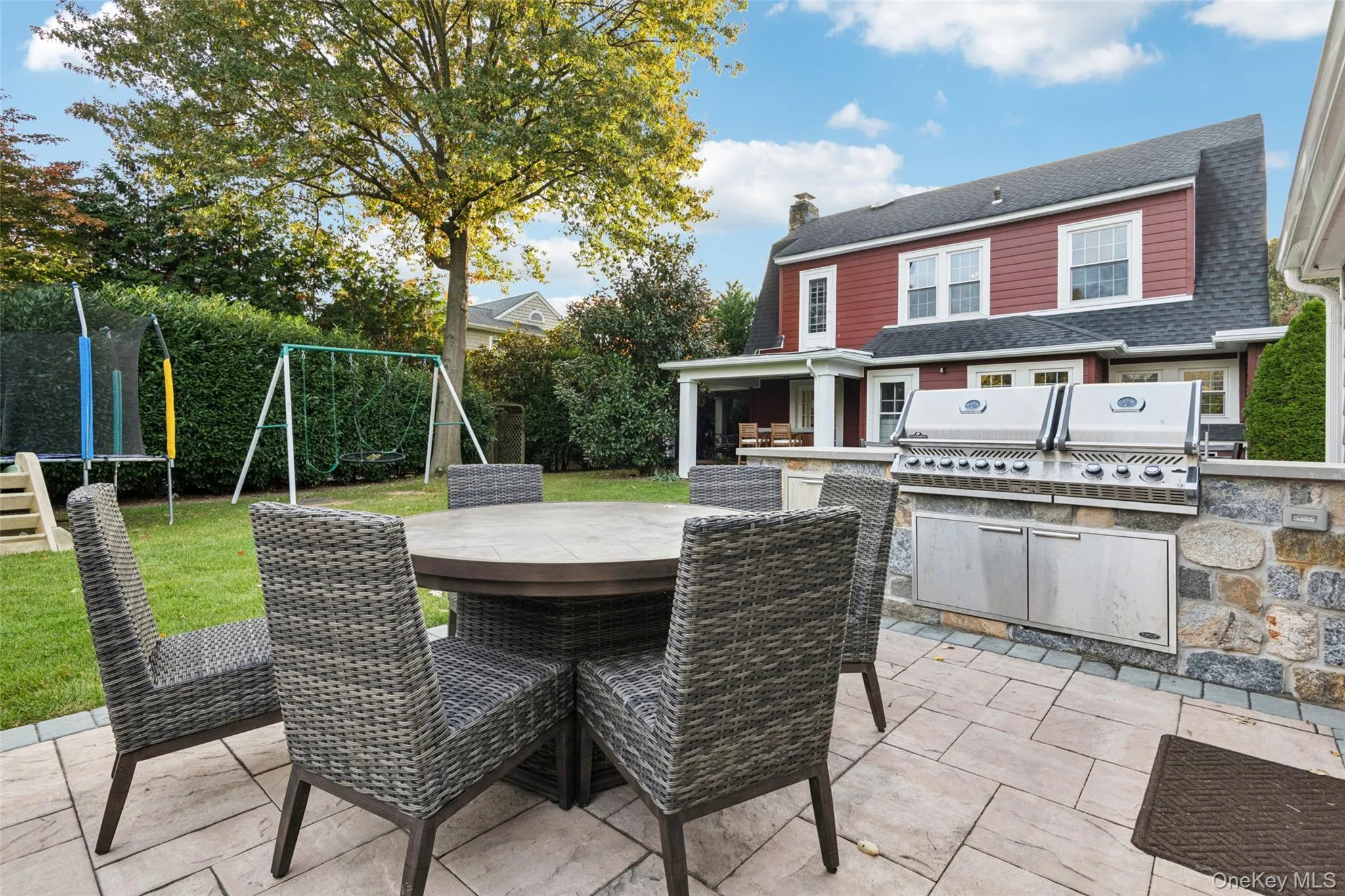 View of patio with exterior kitchen, a trampoline, and outdoor dining area View of patio with exterior kitchen, a trampoline, and outdoor dining area