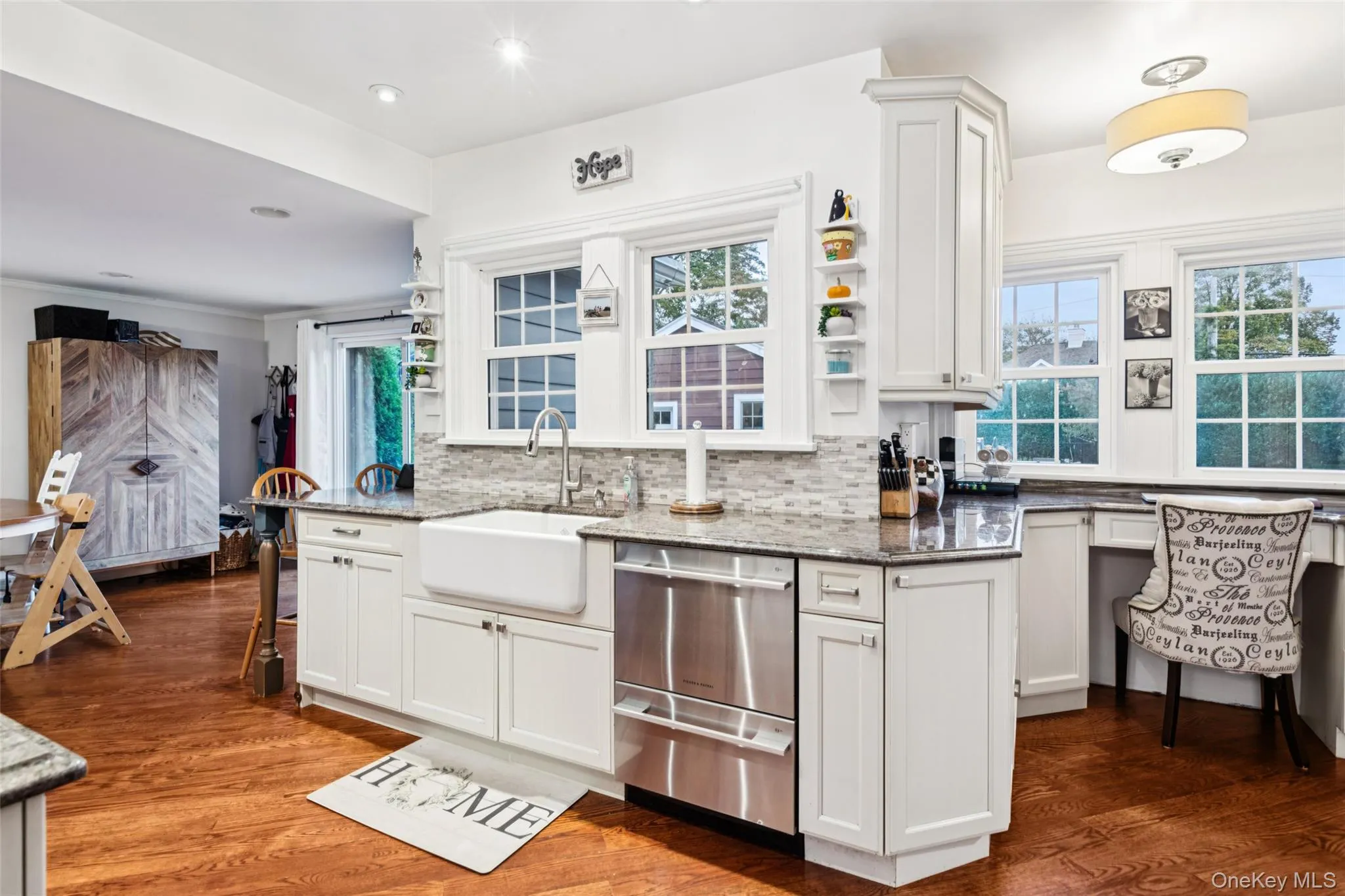 Kitchen with open shelves, decorative backsplash, dark stone countertops, dark wood-type flooring, and recessed lighting Kitchen with open shelves, decorative backsplash, dark stone countertops, dark wood-type flooring, and recessed lighting
