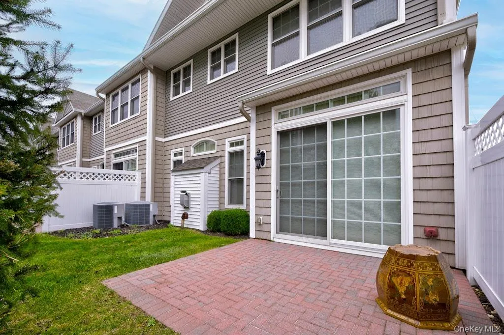 Rear view of house with a patio area Rear view of house with a patio area