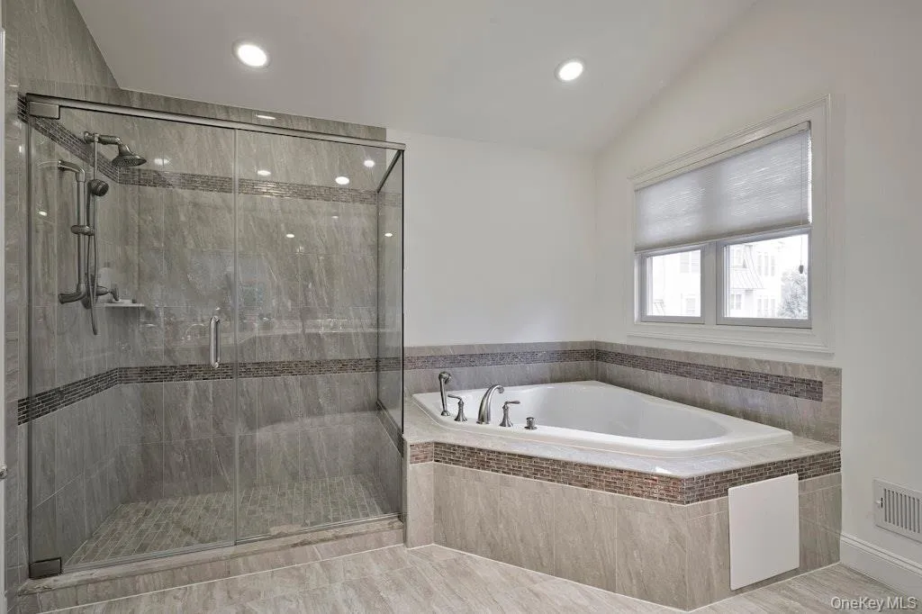 Bathroom featuring a bath, a stall shower, and recessed lighting Bathroom featuring a bath, a stall shower, and recessed lighting