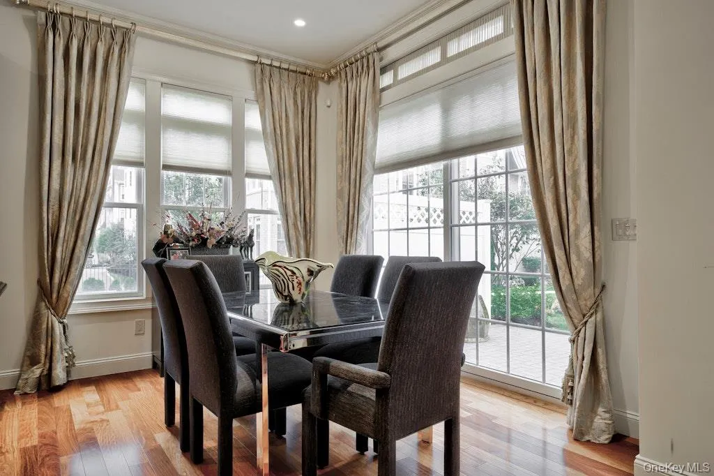 Dining area featuring plenty of natural light and light wood-style flooring Dining area featuring plenty of natural light and light wood-style flooring