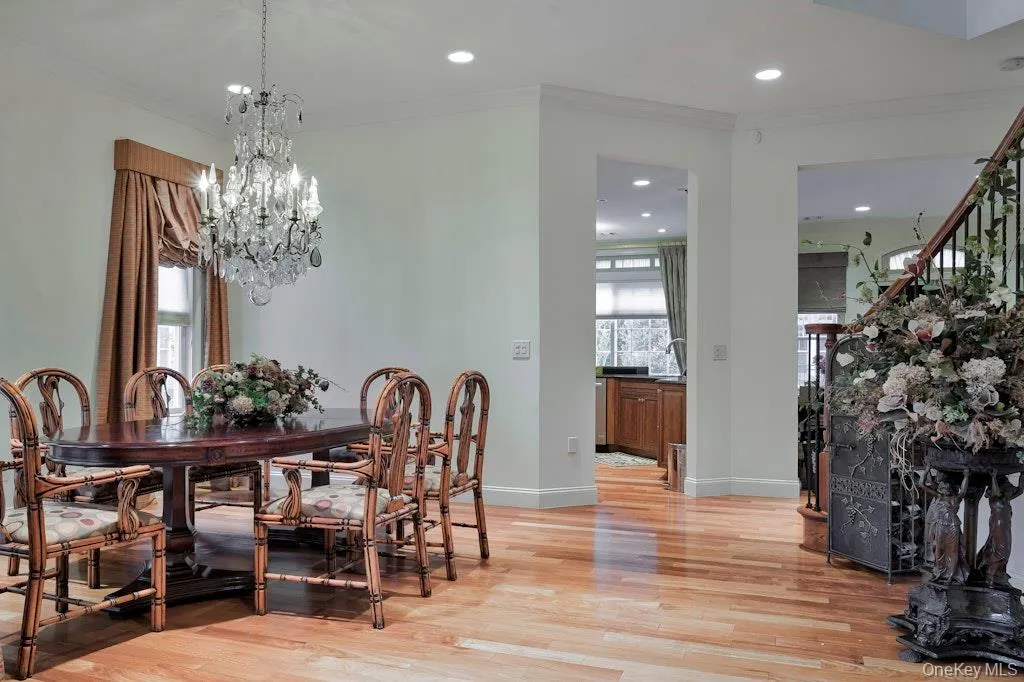 Dining area featuring ornamental molding, recessed lighting, light wood-style floors, and a chandelier Dining area featuring ornamental molding, recessed lighting, light wood-style floors, and a chandelier