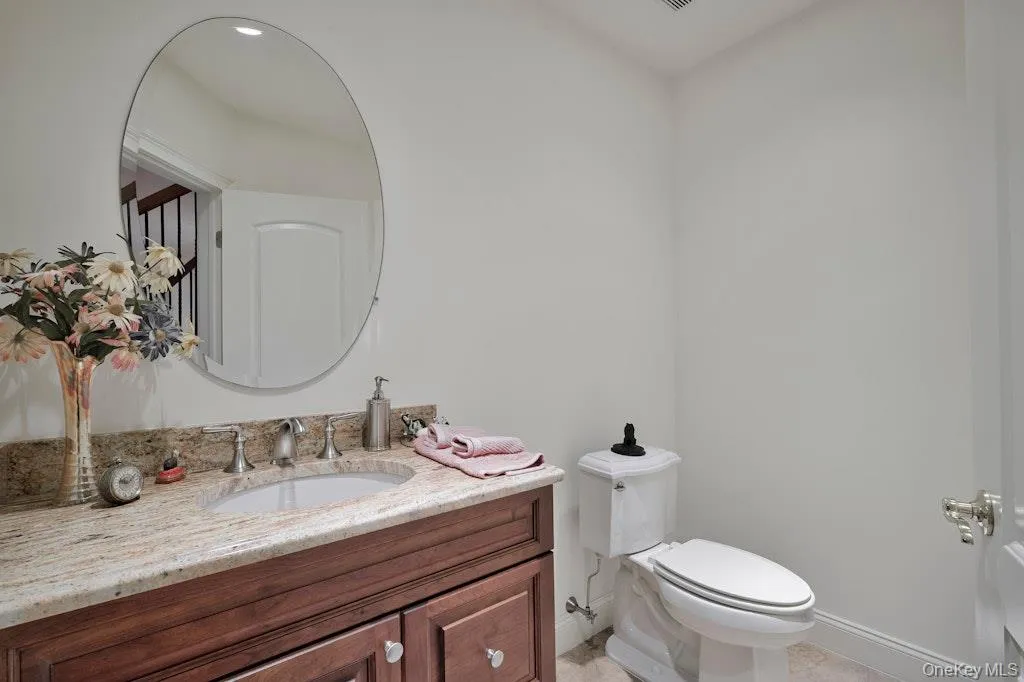 Half bath with vanity and light tile patterned floors Half bath with vanity and light tile patterned floors