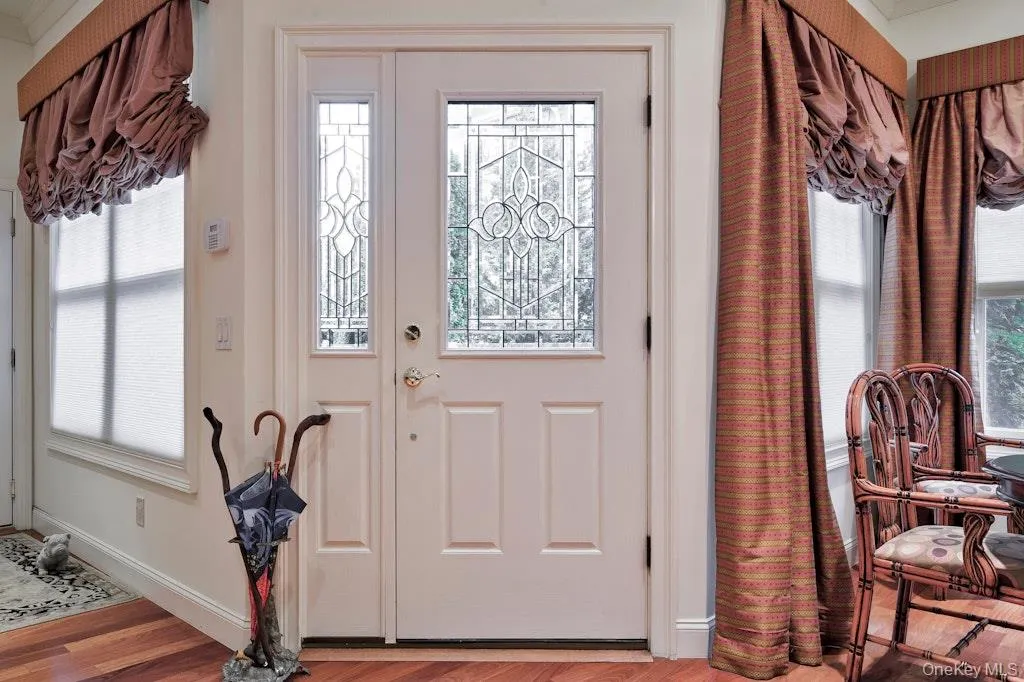 Foyer with plenty of natural light and wood finished floors Foyer with plenty of natural light and wood finished floors
