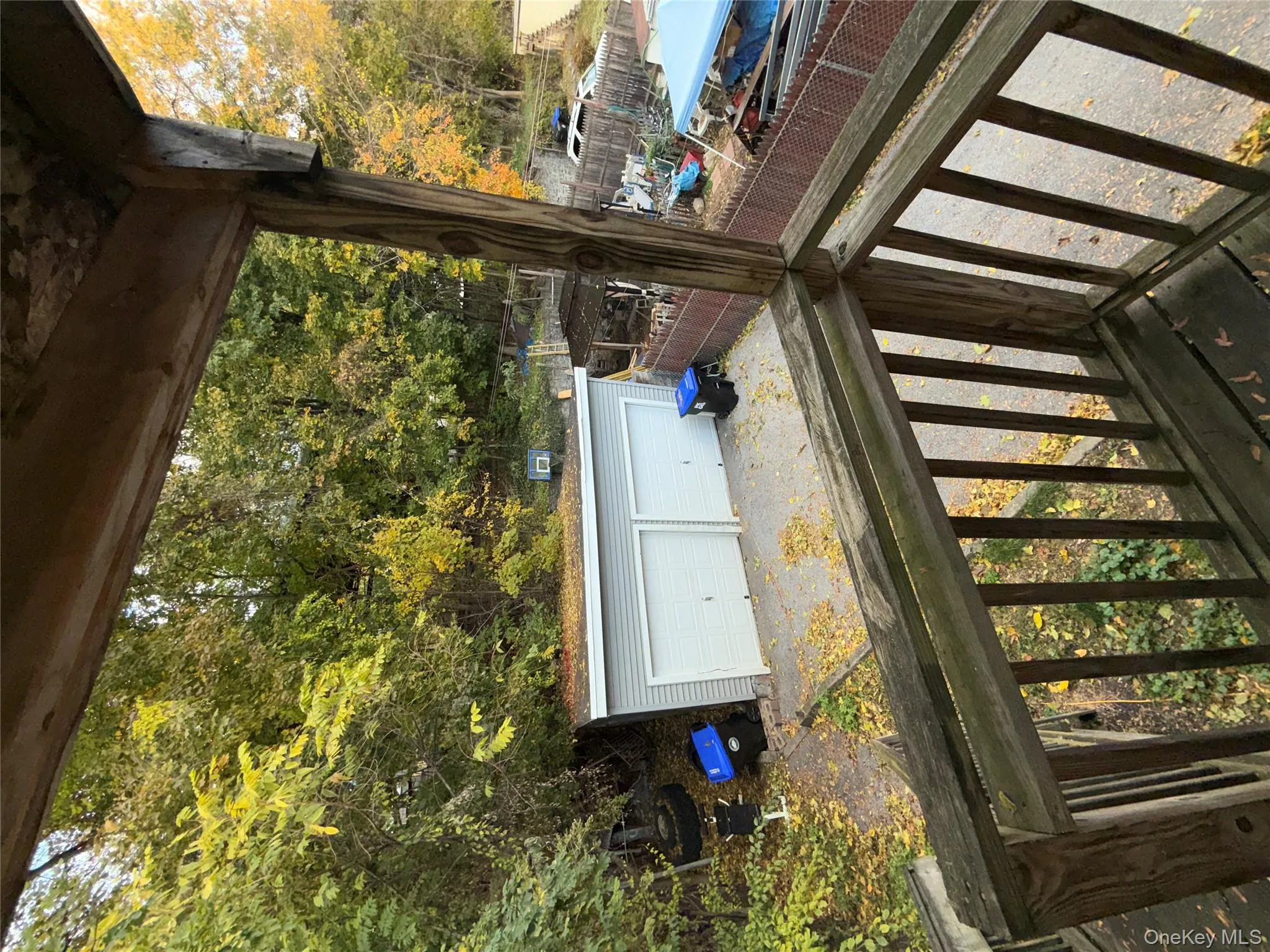 Deck featuring an outdoor structure and a detached garage Deck featuring an outdoor structure and a detached garage