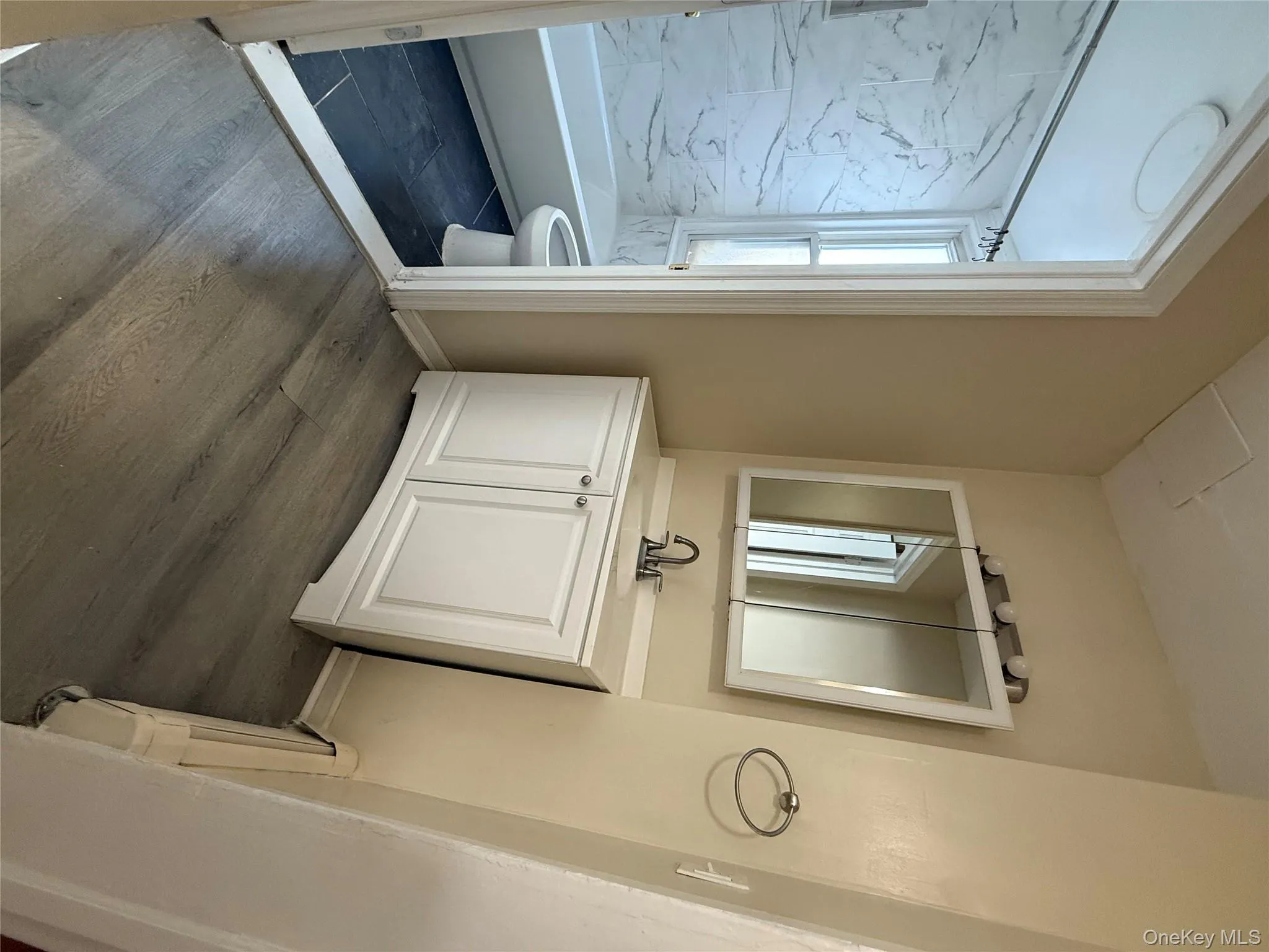 Full bath with vanity, dark wood-type flooring, and tub / shower combination Full bath with vanity, dark wood-type flooring, and tub / shower combination