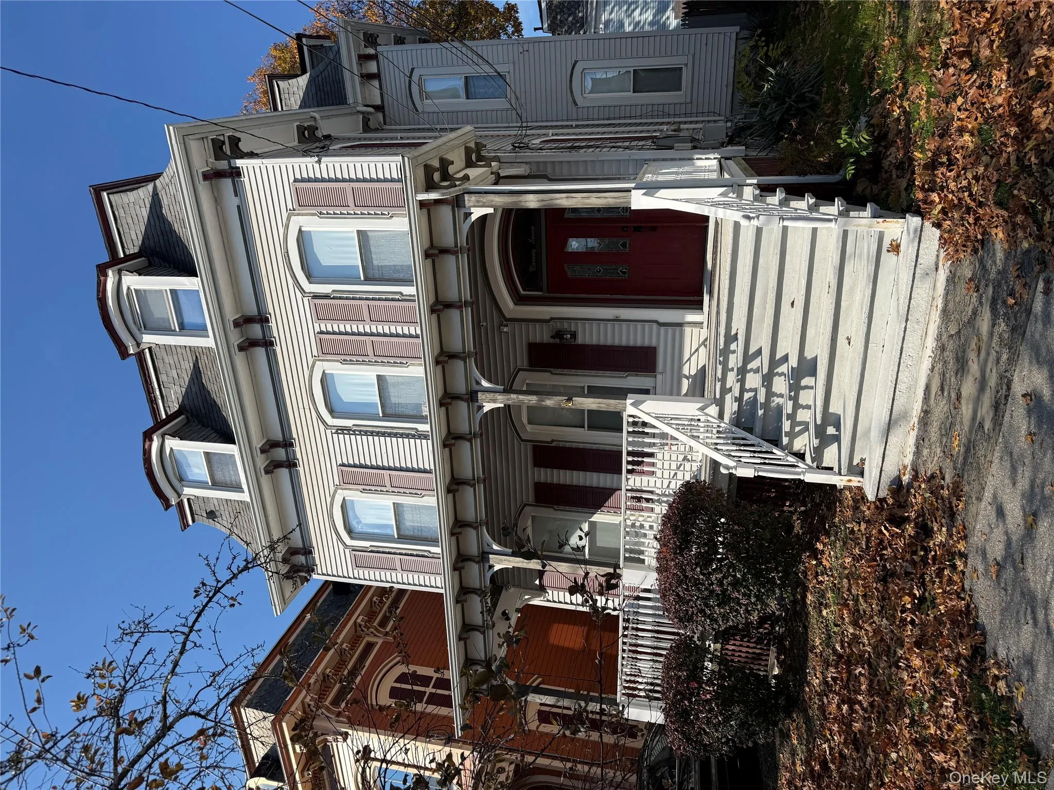 Second empire-style home with mansard roof and covered porch Second empire-style home with mansard roof and covered porch
