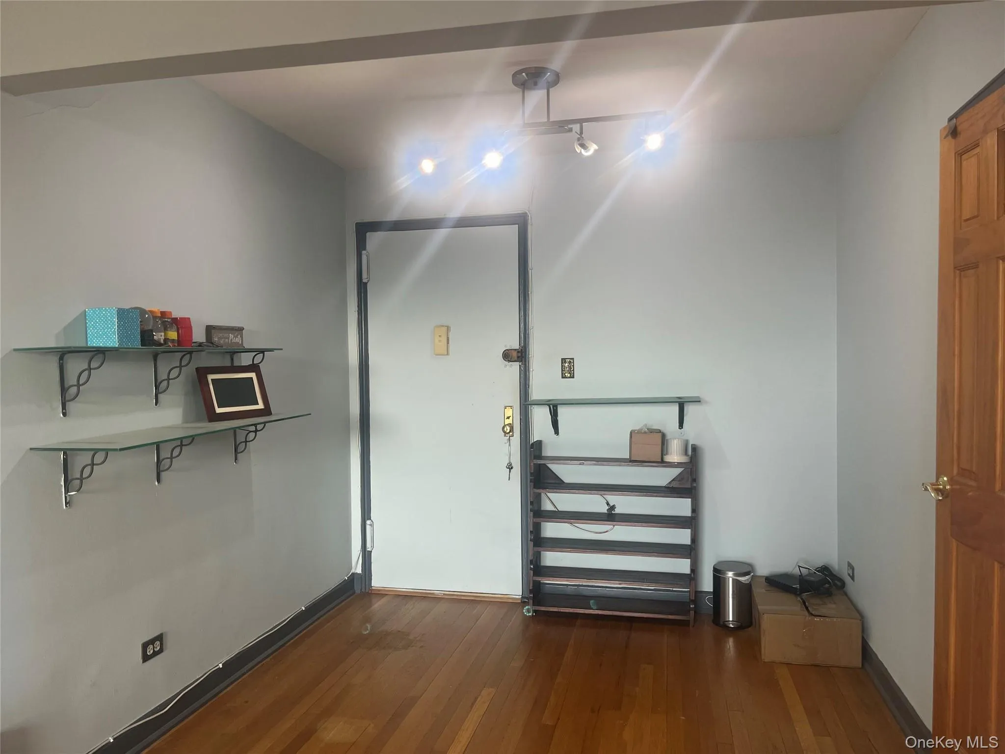 Entrance foyer featuring dark wood finished floors and baseboards Entrance foyer featuring dark wood finished floors and baseboards