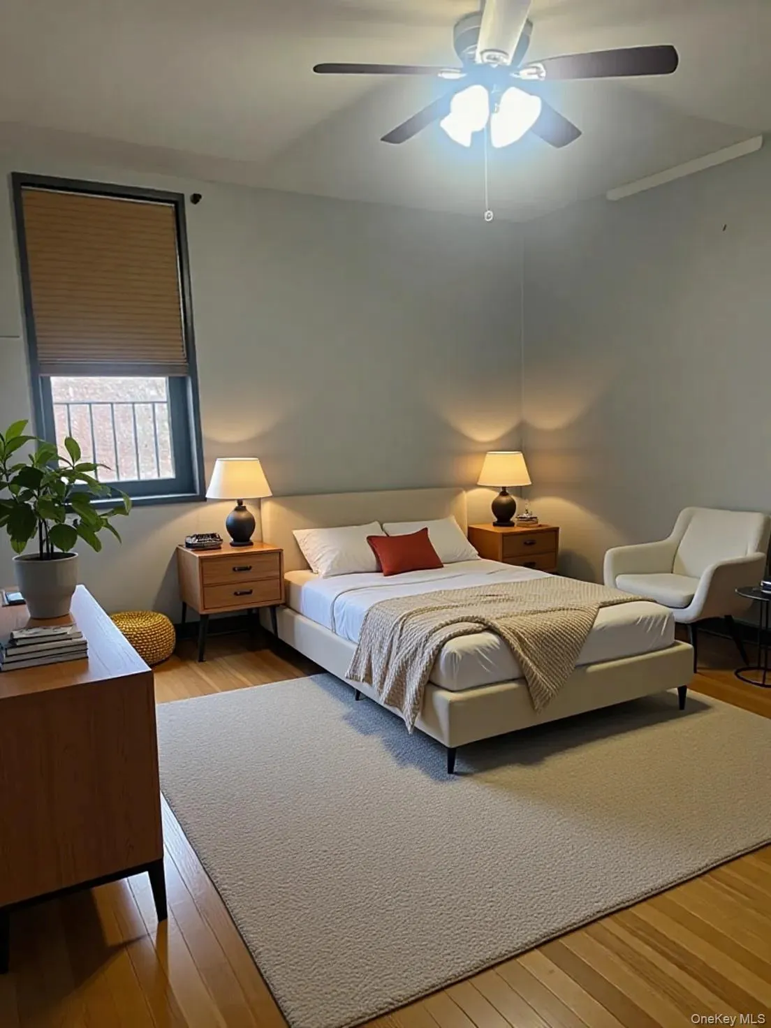 Bedroom featuring light wood-style floors and a ceiling fan Bedroom featuring light wood-style floors and a ceiling fan