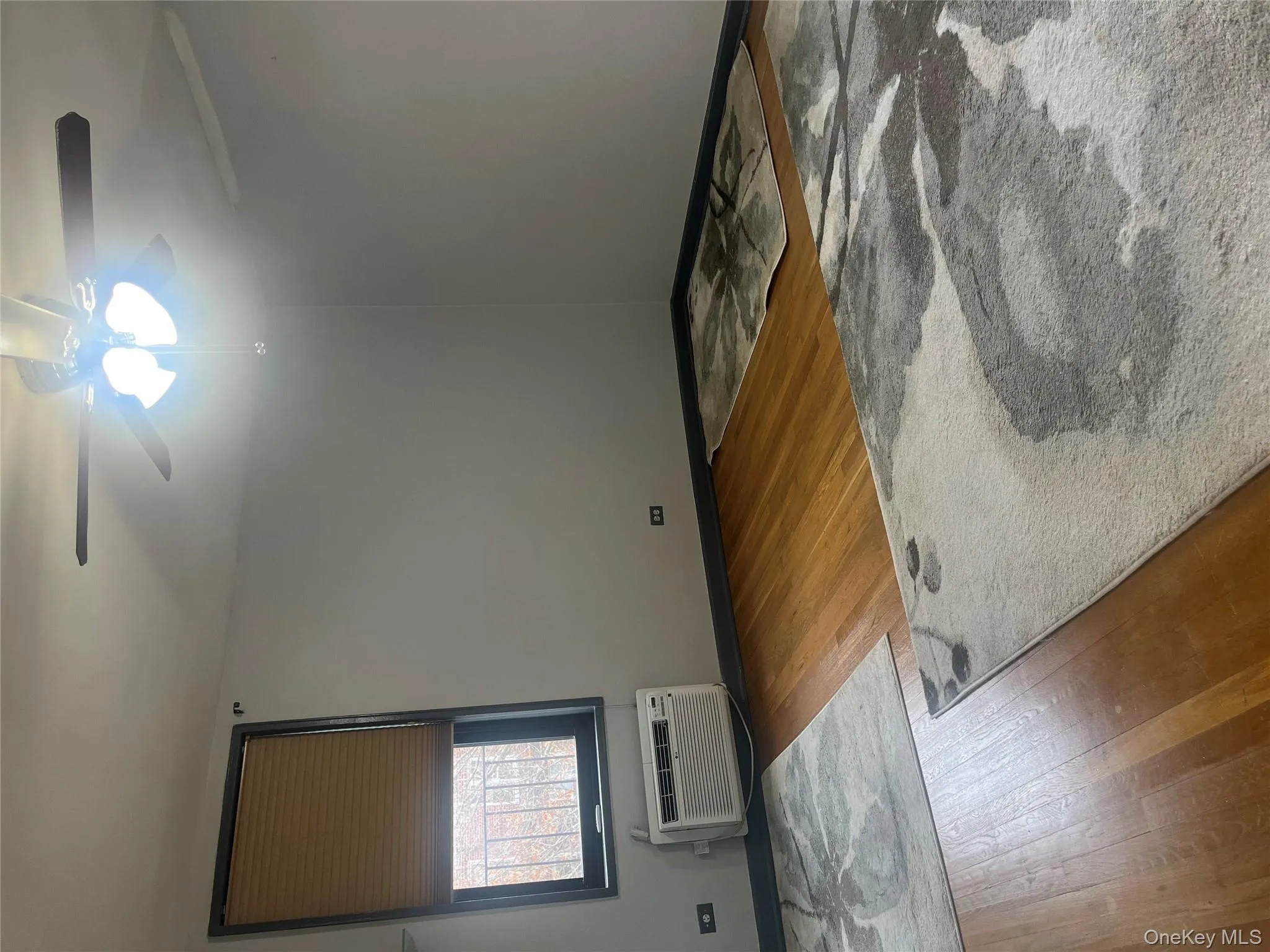 Spare room with light wood finished floors and a wall unit AC Spare room with light wood finished floors and a wall unit AC