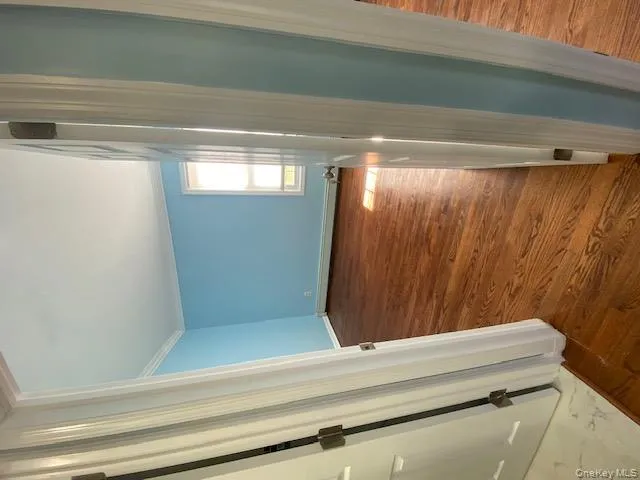 Spare room featuring dark wood-type flooring, crown molding, and baseboard heating Spare room featuring dark wood-type flooring, crown molding, and baseboard heating
