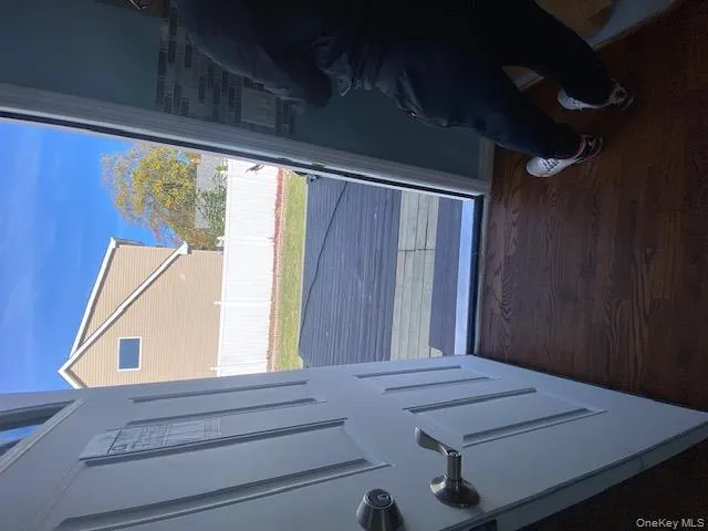 Doorway to outside with wood finished floors Doorway to outside with wood finished floors