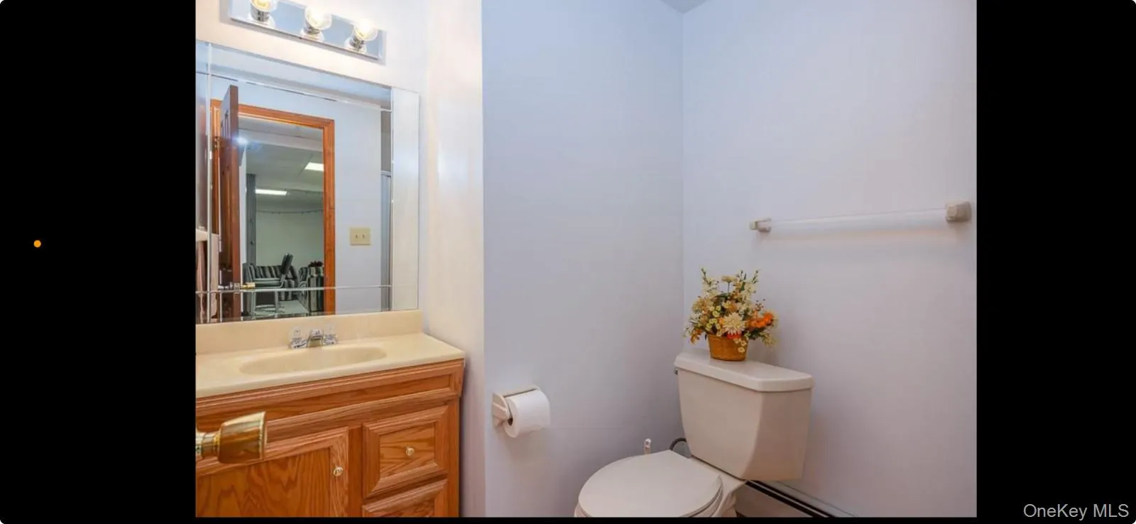 Half bath with vanity and baseboard heating Half bath with vanity and baseboard heating