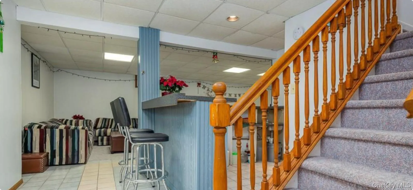 Staircase with a paneled ceiling and tile patterned flooring Staircase with a paneled ceiling and tile patterned flooring