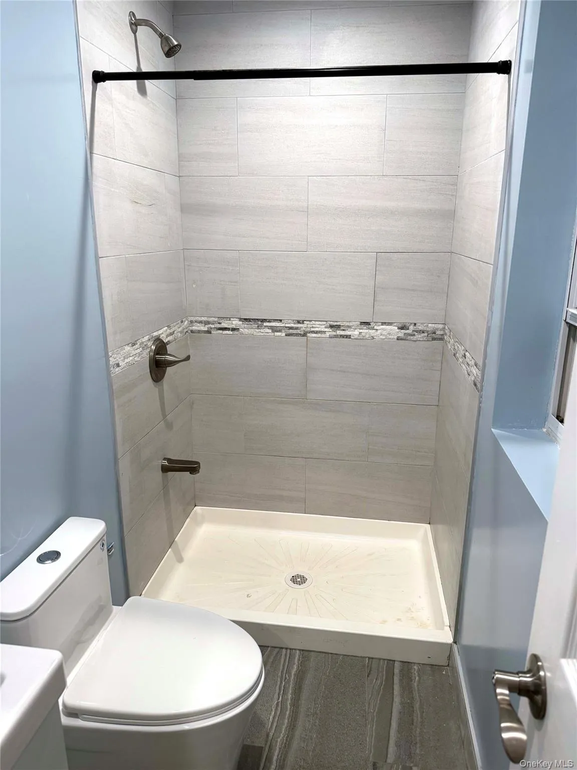 Full bath featuring a shower stall and vanity Full bath featuring a shower stall and vanity