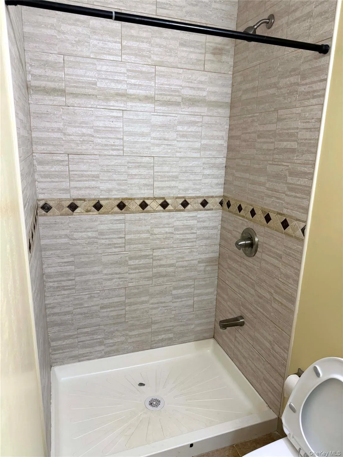 Full bathroom with a shower stall and toilet Full bathroom with a shower stall and toilet