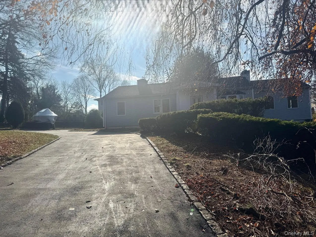 View of front of property with a chimney and driveway View of front of property with a chimney and driveway