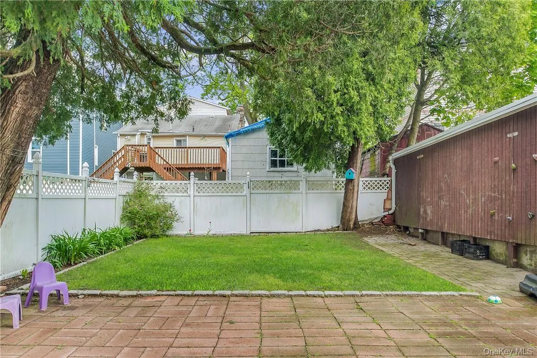 Enjoy the shared backyard with stone patio and fenced perimeter Enjoy the shared backyard with stone patio and fenced perimeter