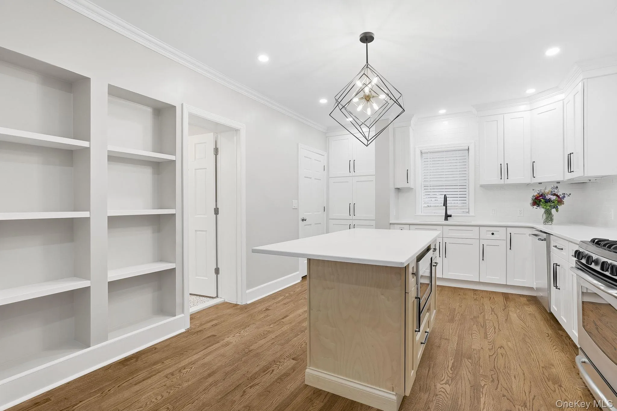 There is open storage space in the kitchen and new wood floors and recessed lighting There is open storage space in the kitchen and new wood floors and recessed lighting