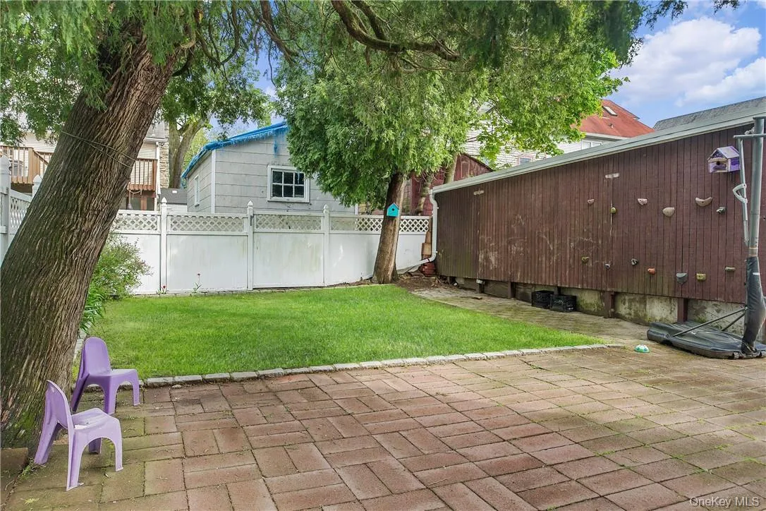 Alternate view of the backyard with the side of the garage on right Alternate view of the backyard with the side of the garage on right