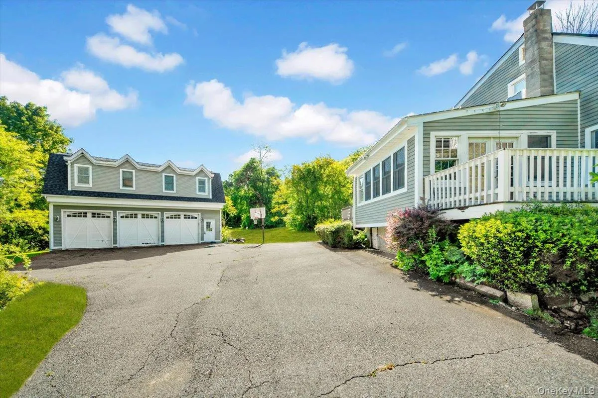 View of home's exterior featuring a garage and driveway View of home's exterior featuring a garage and driveway