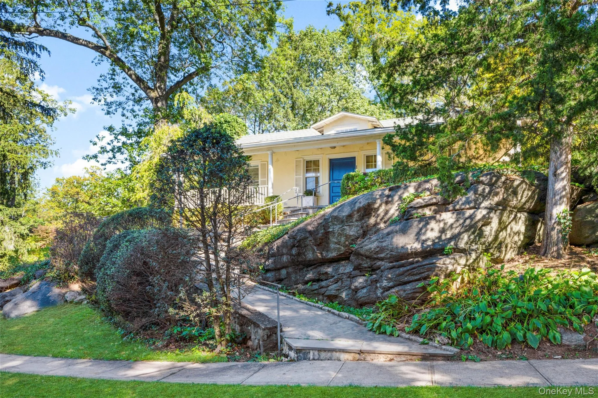 View of front facade with a porch and stucco siding View of front facade with a porch and stucco siding